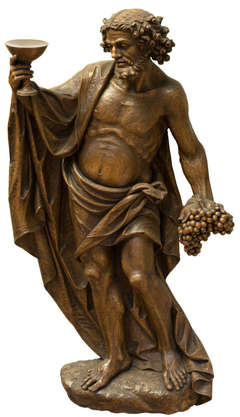 A monumental wood wall sculpture of Bacchus