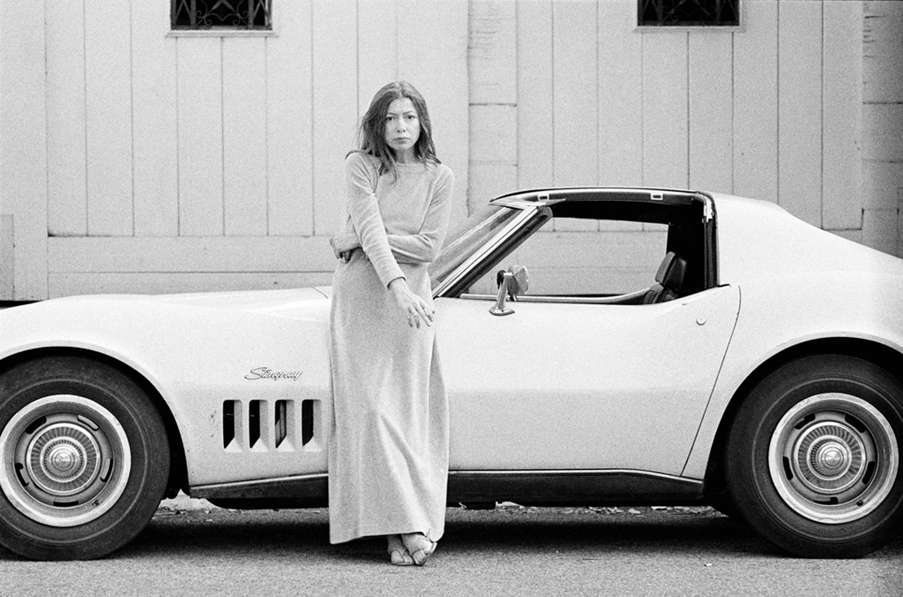 Julian Wasser Figurative Photograph - Joan Didion in front of her Stingray Corvette, 1968