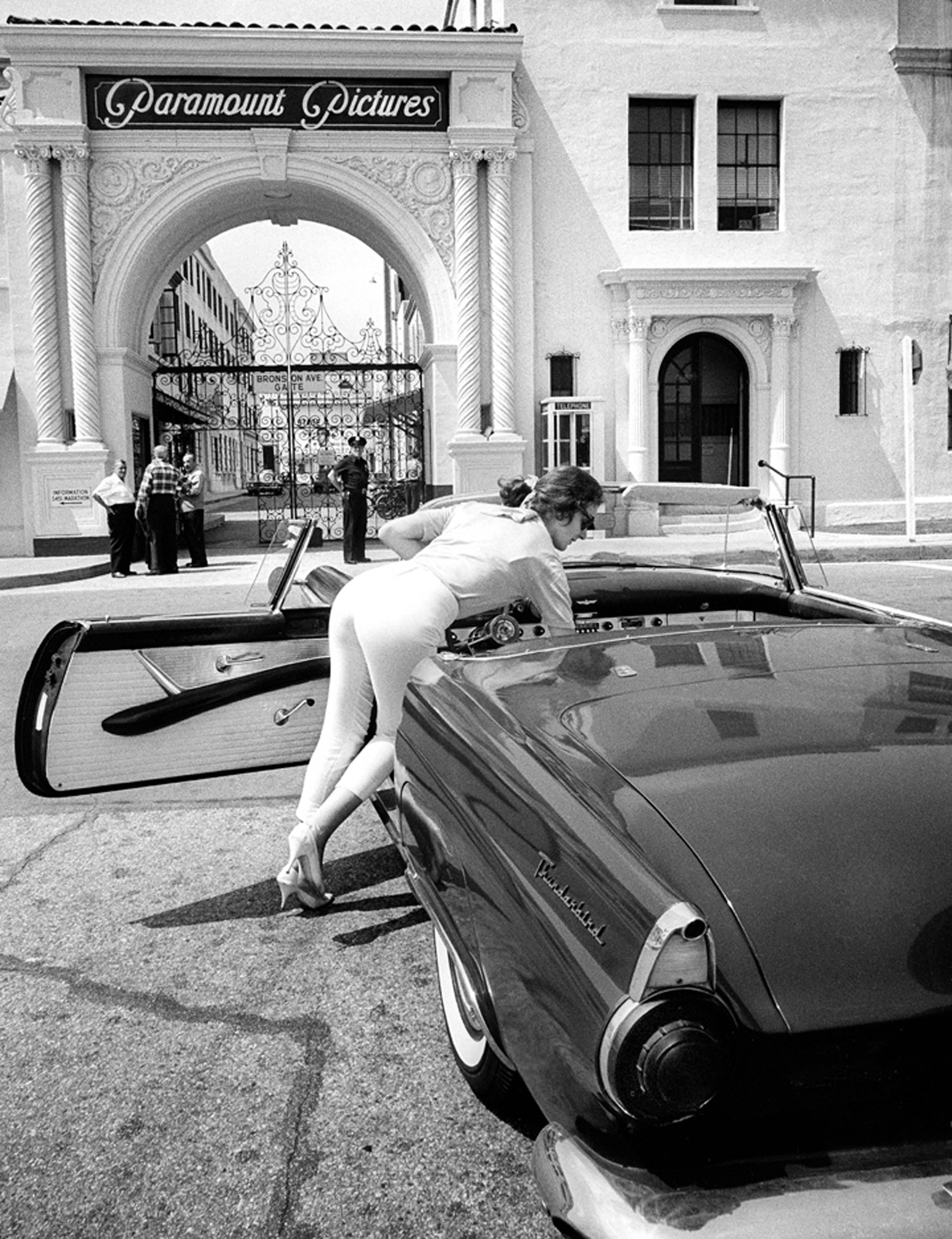 Julian Wasser Figurative Photograph - Woman with T-Bird at Paramount Pictures Studio, 1962