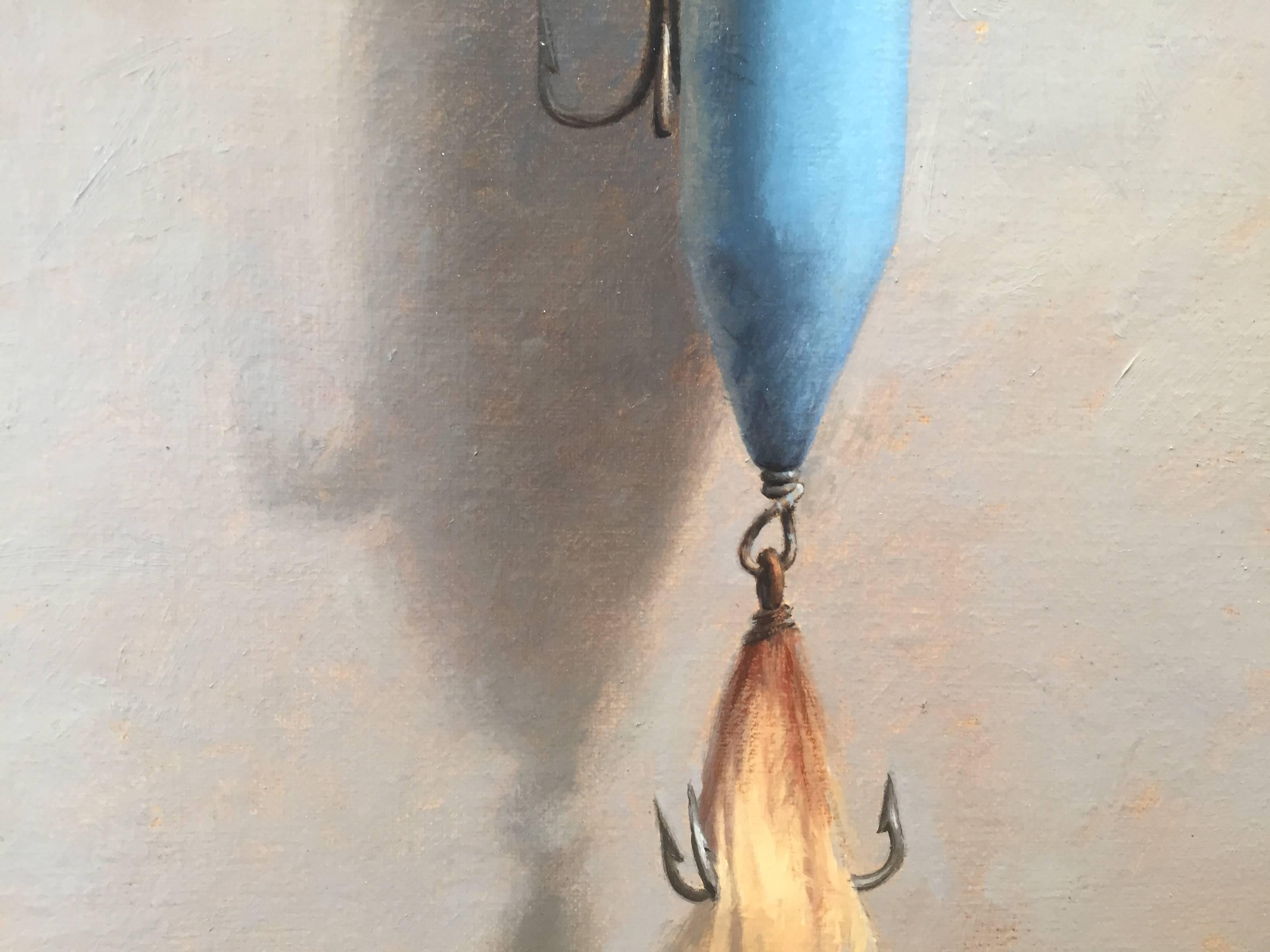 Painted from life in his Connecticut studio, a sky-blue fishing lure hangs from a tiny nail. Small hooks and fishing wire painted with precision. A true contemporary master of Trompe L'oeil. 

John Morfis was born in Glen Cove, Long Island in 1976.