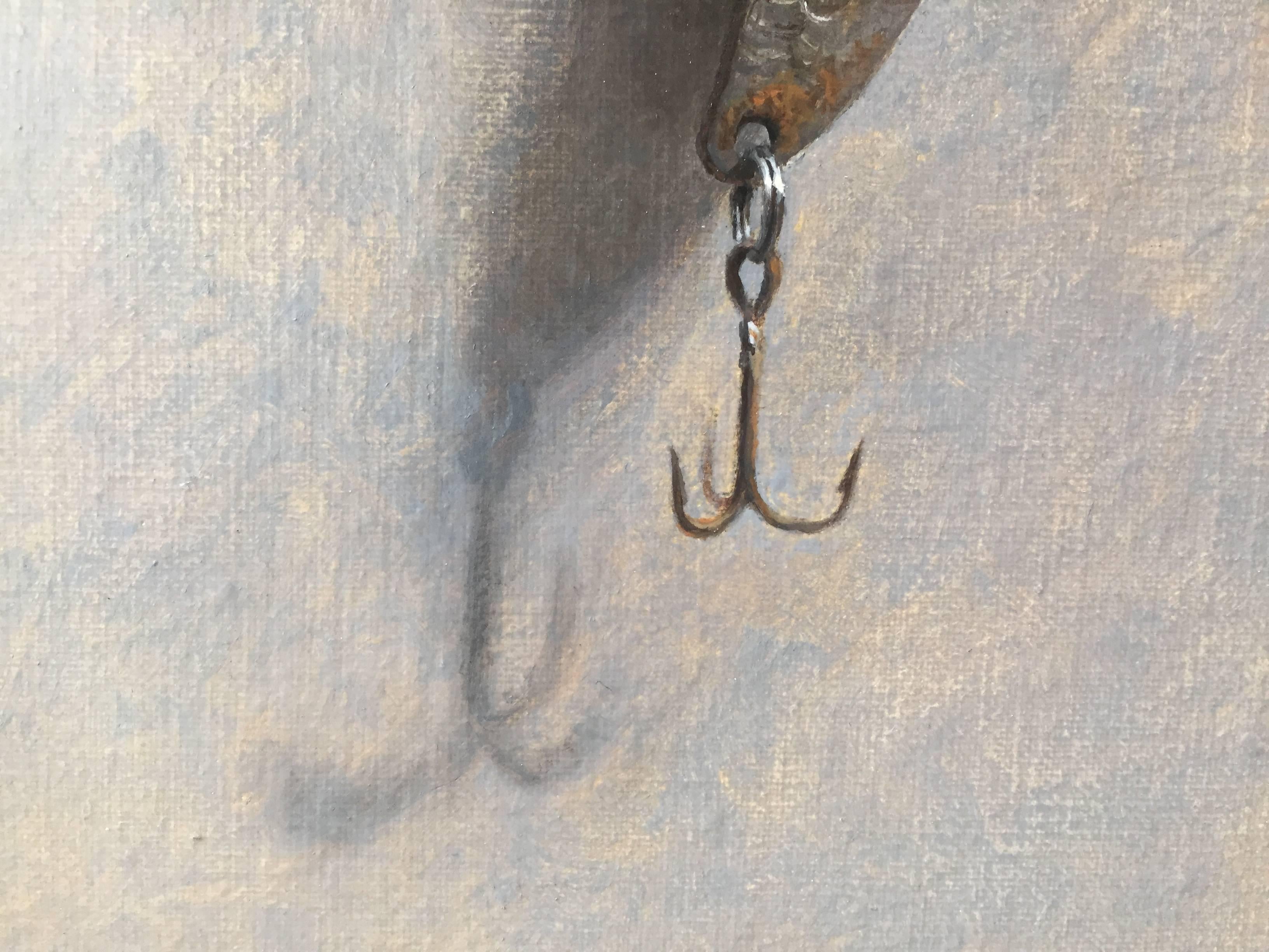 Painted from life, a trompe l'oeil oil painting of a small, rusted silver fishing lure. Hanging from a tiny metal nail, and dangling from a thin white fishing line, Morfis presents to us his aptitude for intricacy. Highlighting a rusted object