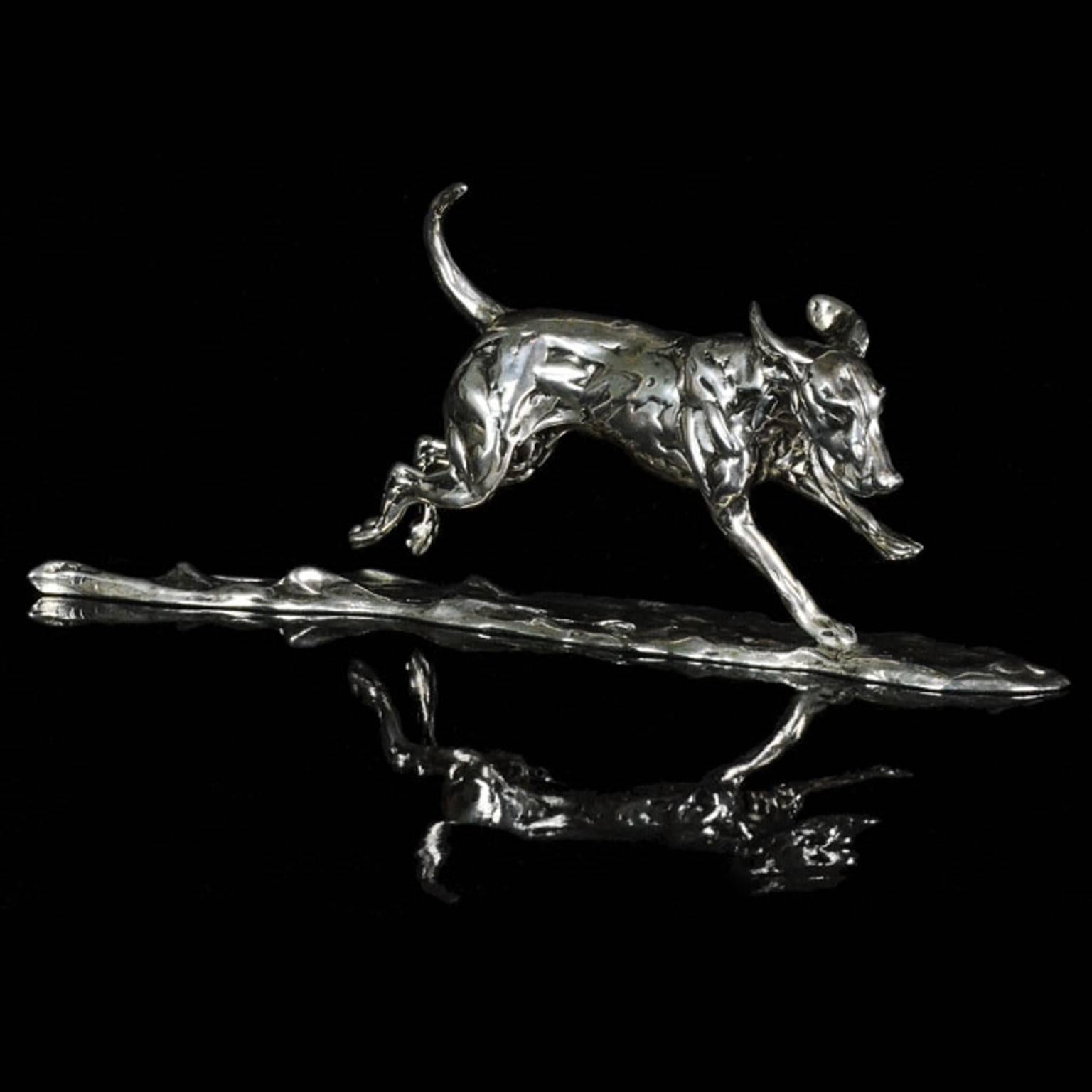 A 'Running Hound' sterling silver sculpture by Lucy Kinsella, the limited edition finely modelled hound depicted galloping across the ground with his tail flying out behind him and the wind whipping his ears around his head.  He has been sculpted in
