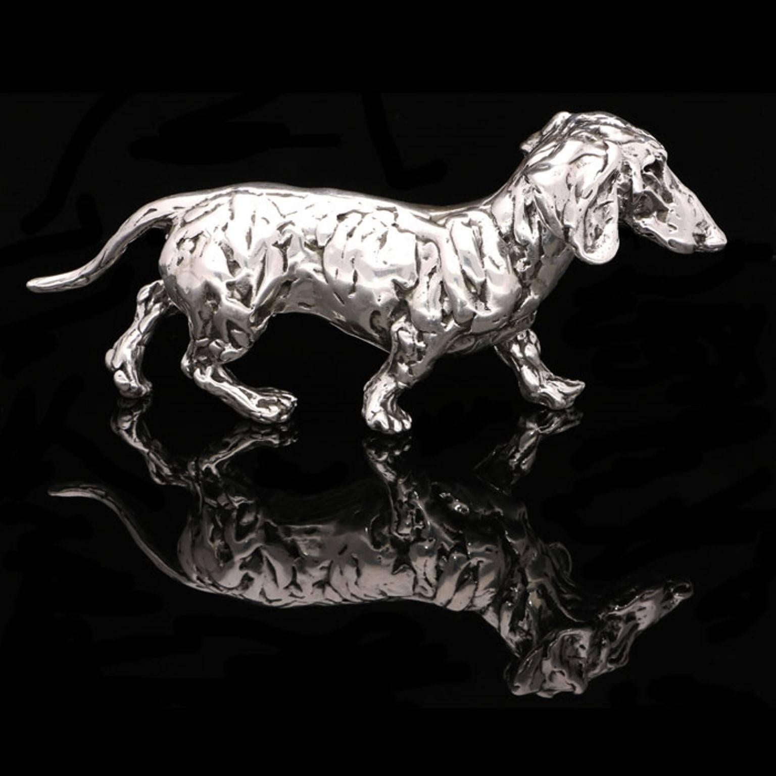 A ‘Dachshund’ sterling silver sculpture by Lucy Kinsella, the limited edition finely modelled dachshund with characteristic elongated body and short legs is depicted striding jauntily along with something of a purposeful expression on his face. 