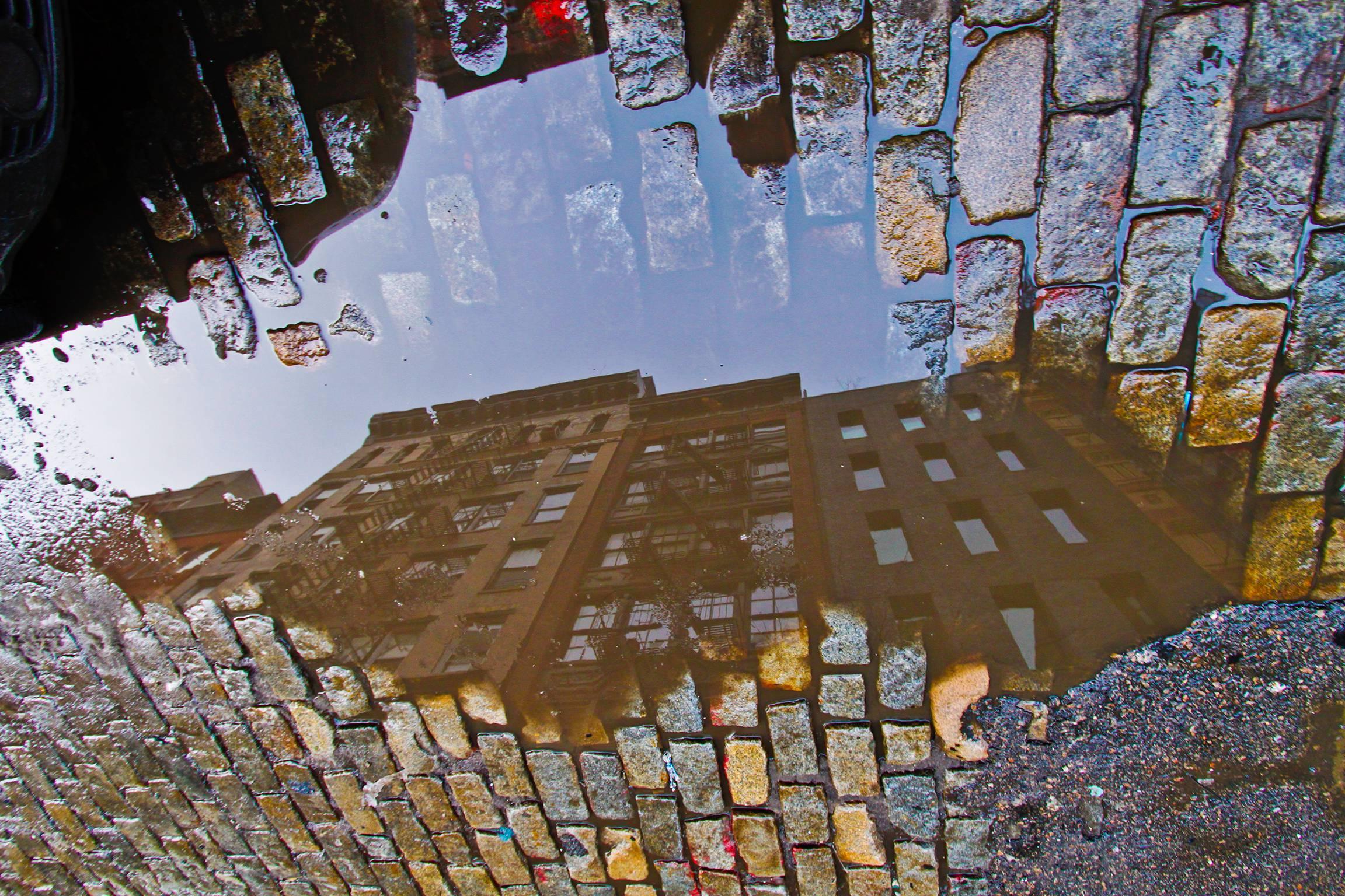 Yancy Clete Christopher Color Photograph - Crosby Street, 2010 buildings reflecting in a water puddle New York in Soho