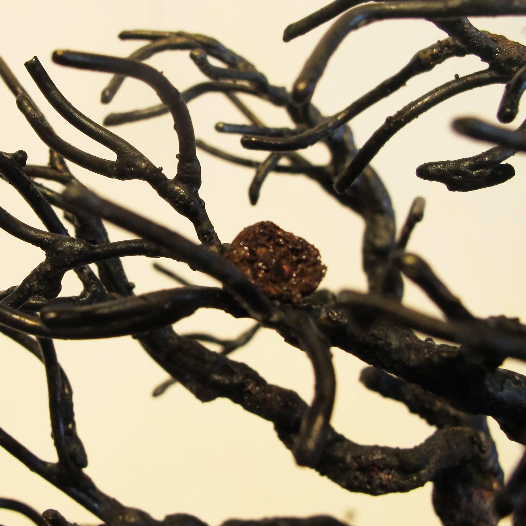 A steel metal tree mounted on a mica base.

Bill Web was raised outside Houston, Texas. This is where he developed the love and fascination with trees.

Each piece begins with a 1/16