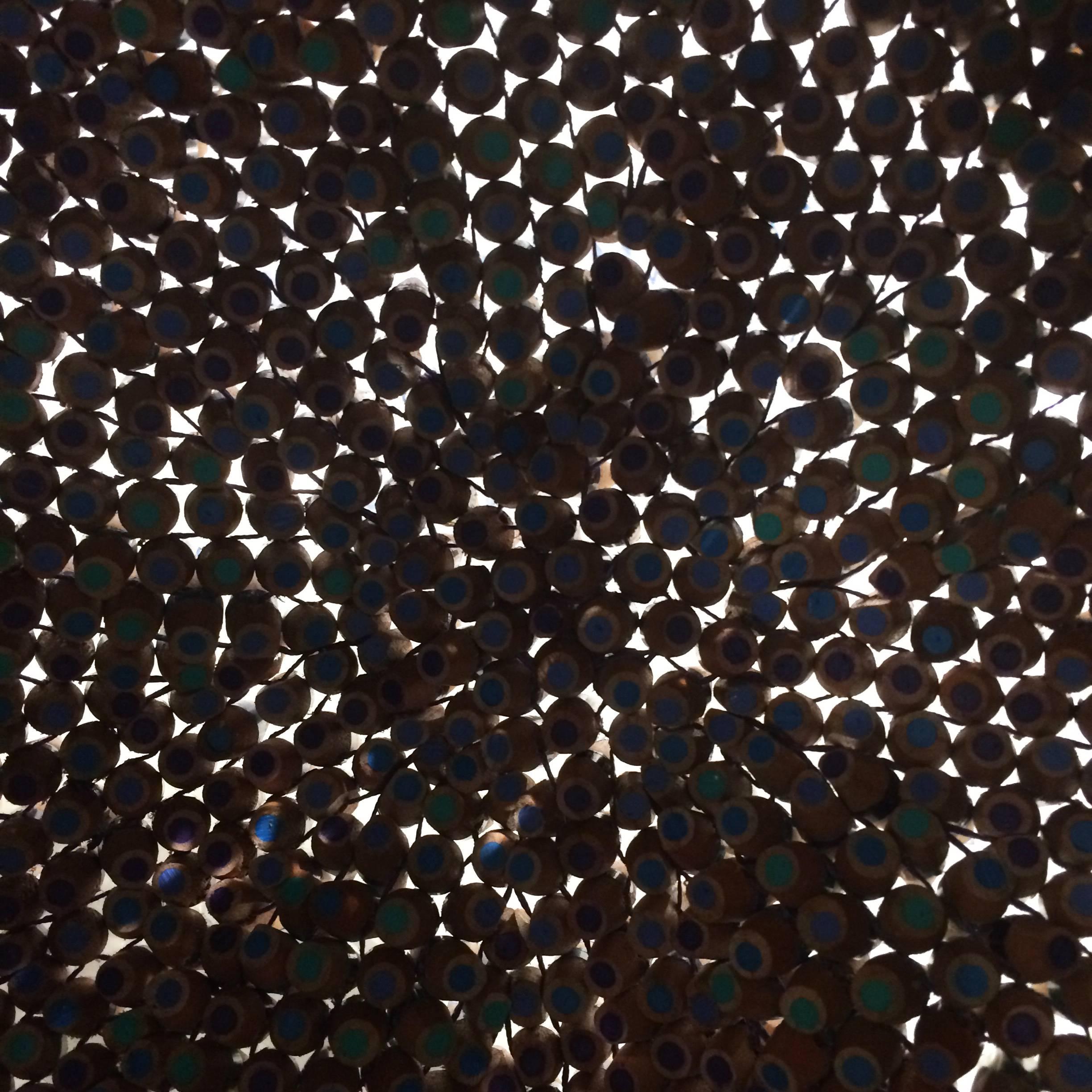 The starfish is made with shades of teal, cerulean, indigo and turquoise. To make each sculpture hundreds of pencils are chosen by color and cut into 1-inch sections. Holes are then drilled in each pencil, turning them into beads, then sharpened and