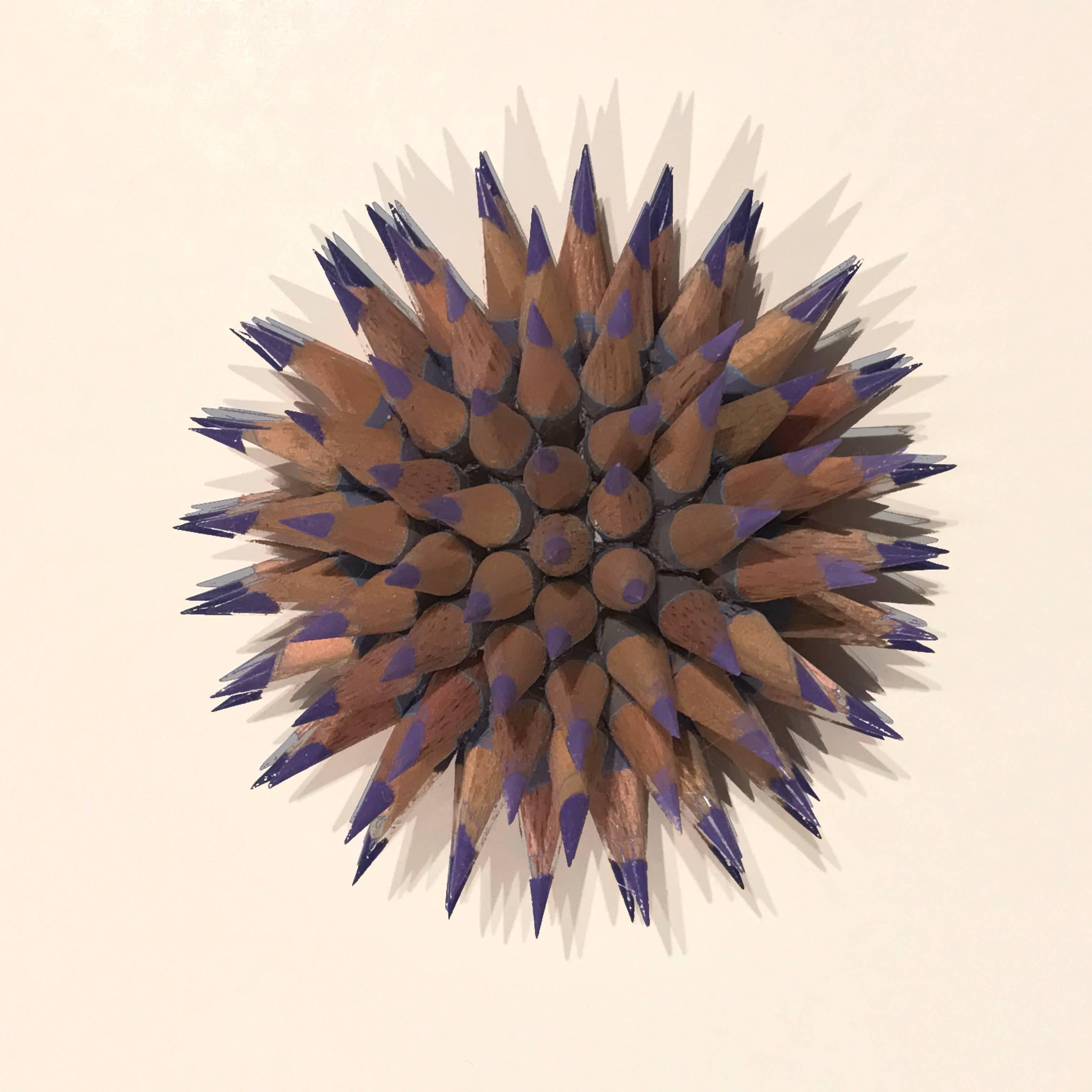 A smokey purple-violet was the chosen color for this sculpture inspired by the sea. To make each sculpture pencils are chosen by color and cut into 1-inch sections. Holes are then drilled in each pencil, turning them into beads, then sharpened and