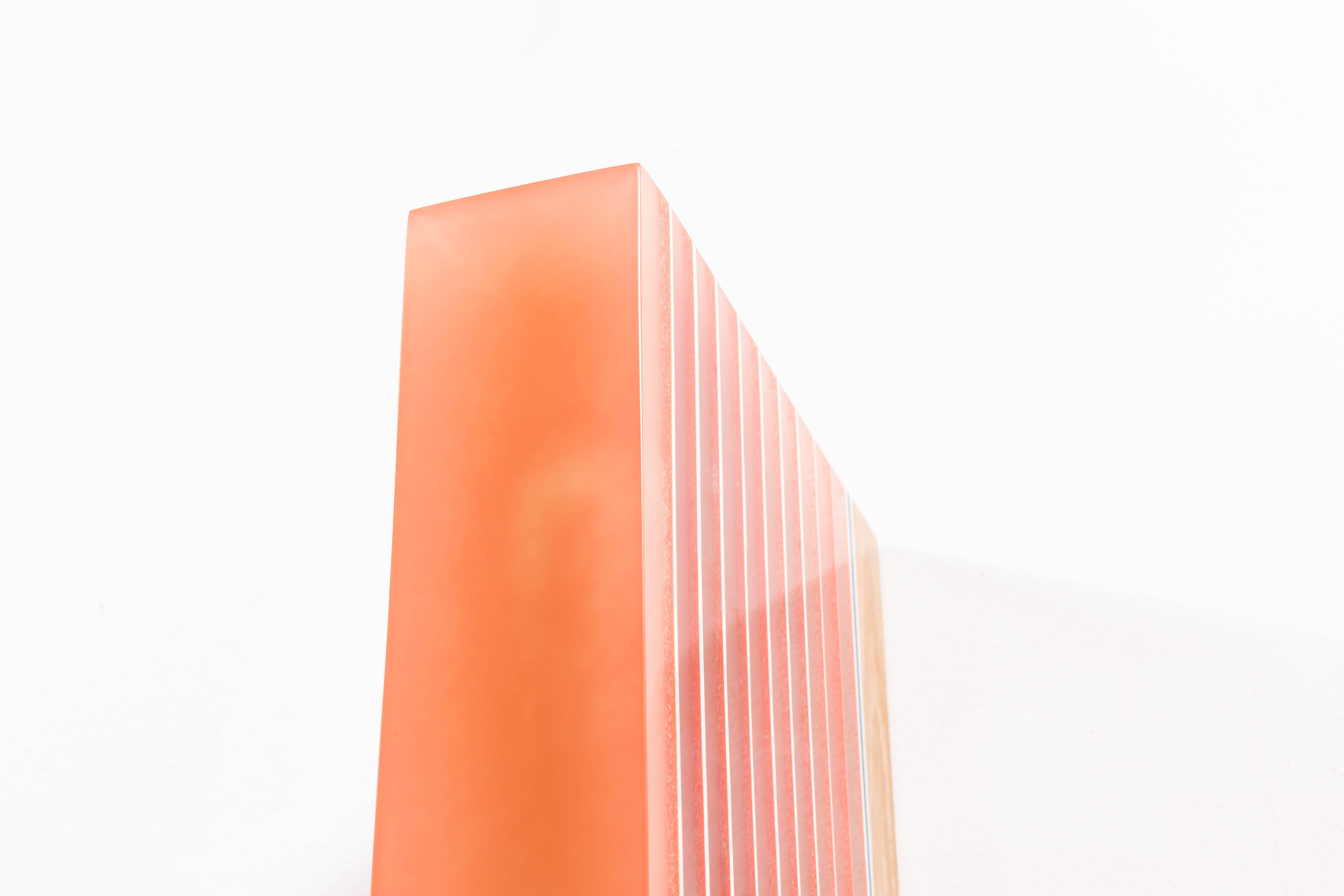 Beige, pale orange, camel, light salmon, salmon and white.
In a technique evolved over years of experimentation, Schmitz-Schmelzer pours resin in parallel or vertical layers onto a plywood-capped base of raw tropical wood. Marriage of the