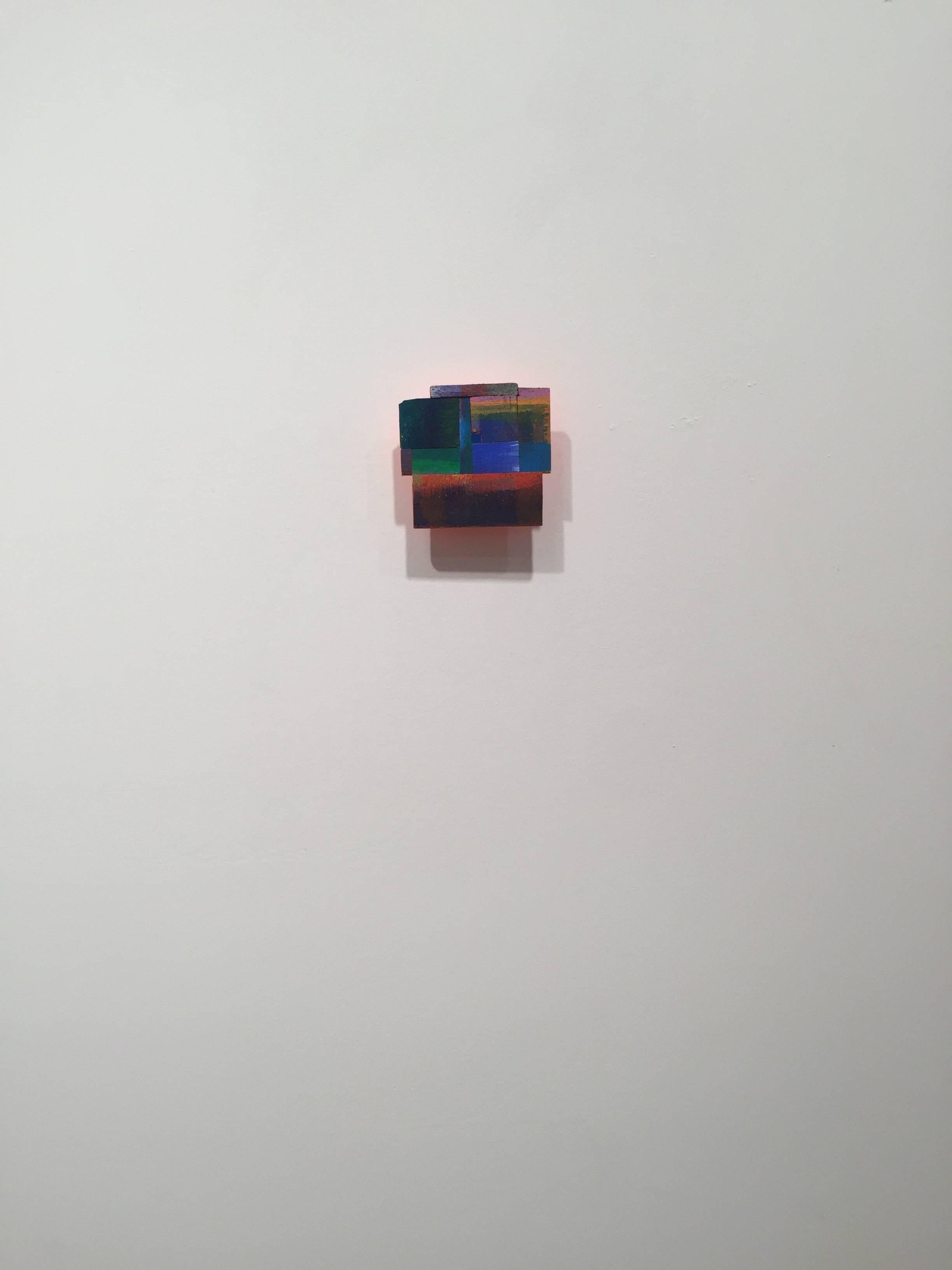 Joan Grubin creates dimensional installations, objects, and smaller wall works that revolve around a collaboration between the physical presence of pigment on paper and the visible but immaterial partners of reflected color, cast shadows, and