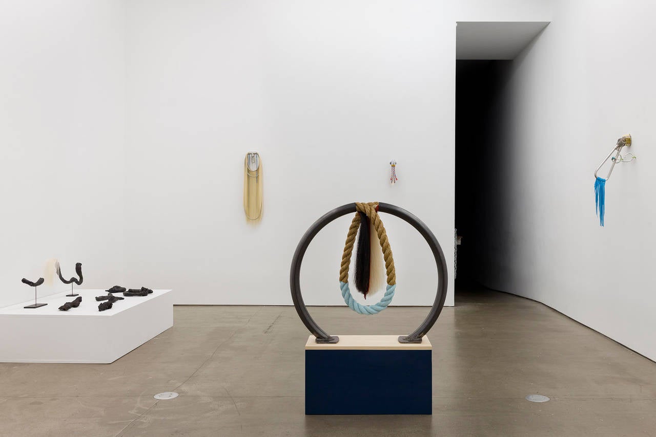 Trish Tillman juxtaposes diverse materials to evoke domestic ritual, fetish, and a modern tendency towards private totemic monuments. Industrial components fused with uncanny decorative elements like hair, leather, rope and chains become unsettling