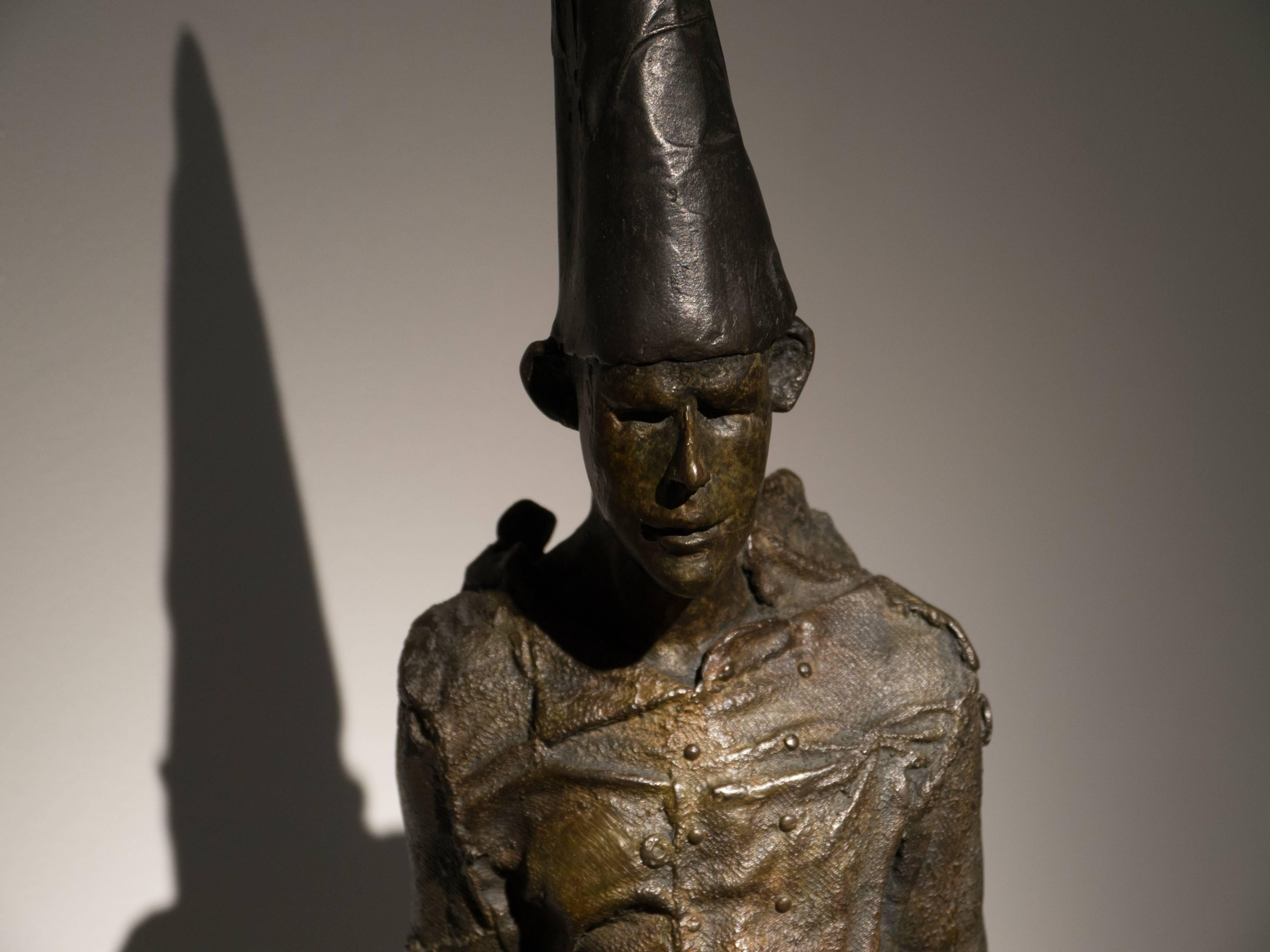 This bronze, contemporary, sculpture of dunce, is medium sized and good for a desk. It has the shape of a seated human figure with a rounded posture.

Anyone who shares Beth Carter’s fascination with the human condition must surely embrace the
