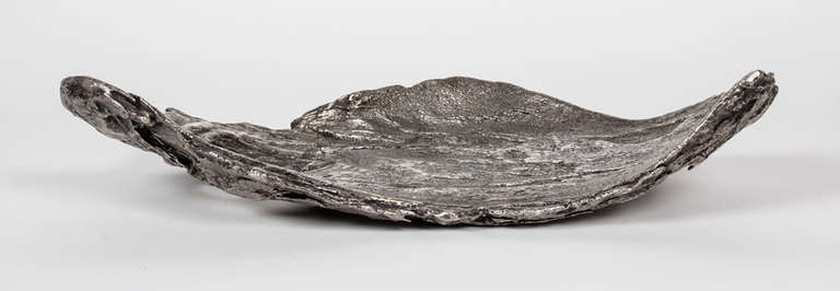MICHELE OKA DONER (b. 1945) USA 

Tree Bark server (unique) 1998 

Solid cast silver in a naturalistic form of a piece of tree bark with an inherent hole.

 ***The weight is in excess of 250 troy ounces of silver 

Exhibited: Inside Design