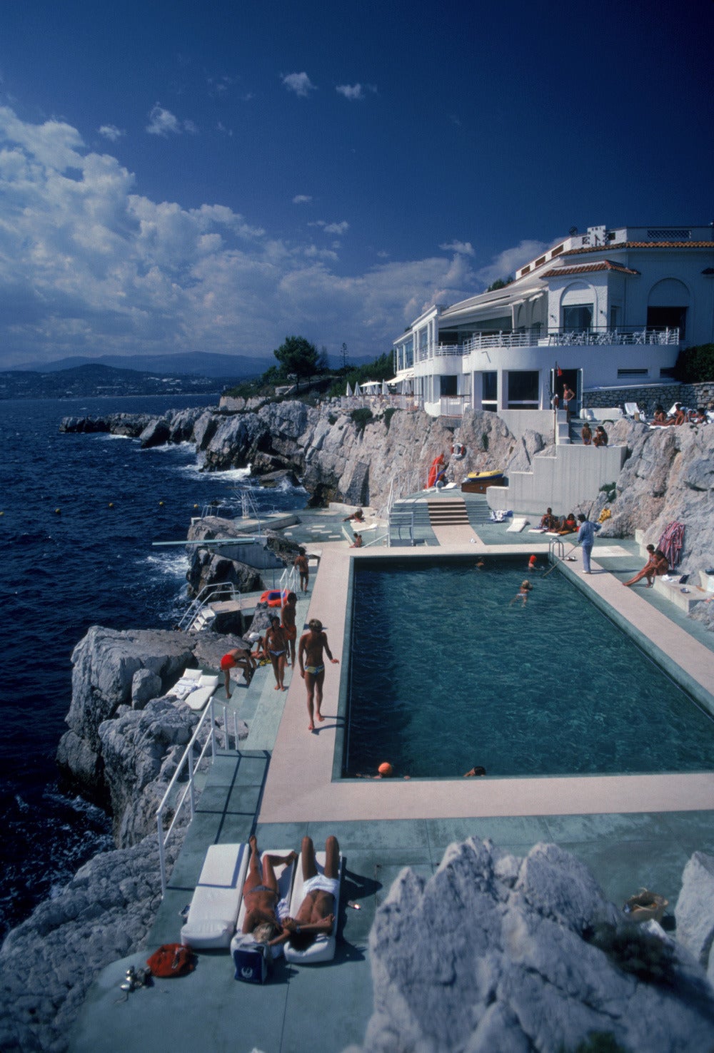 Slim Aarons Color Photograph - Guests by the pool at the Hotel du Cap Eden-Roc, Antibes, France