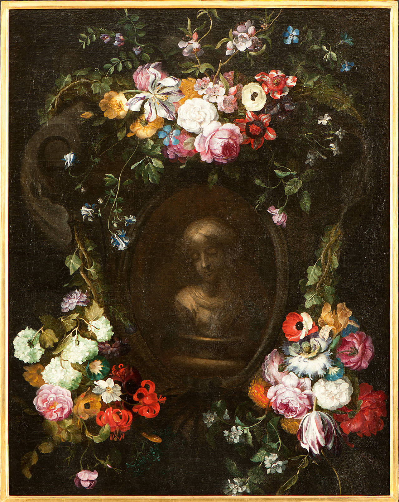 Swags of flowers adorning a grisaille cartouche with a bust of a girl