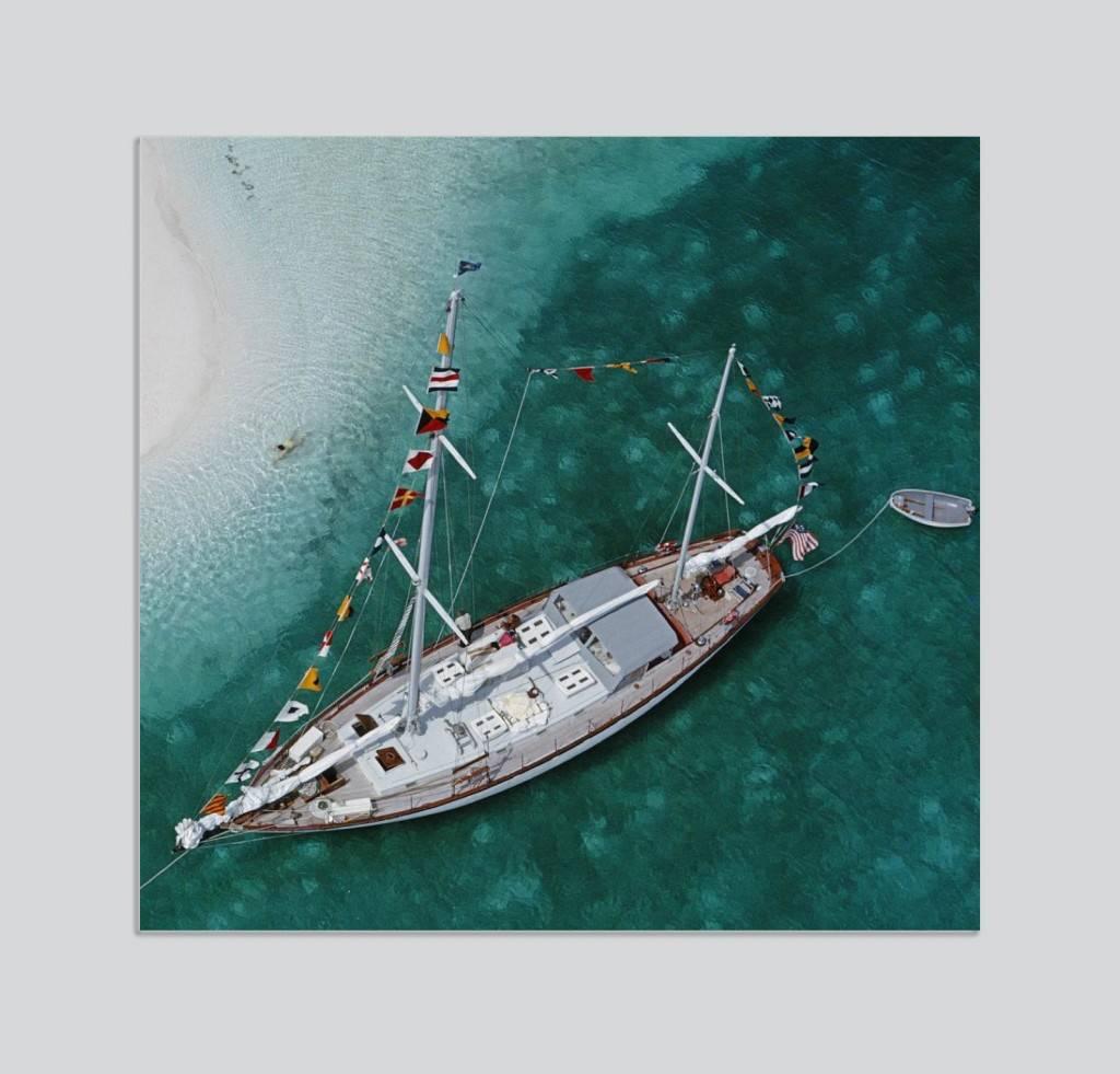 'Charter Ketch' by Slim Aarons

Sixty eight foot charter ketch 'Traveller II' at anchor in the lee of Stocking Island, across the harbour from George Town, Exuma, circa 1960.

This photograph epitomises the travel style and glamour of the period's