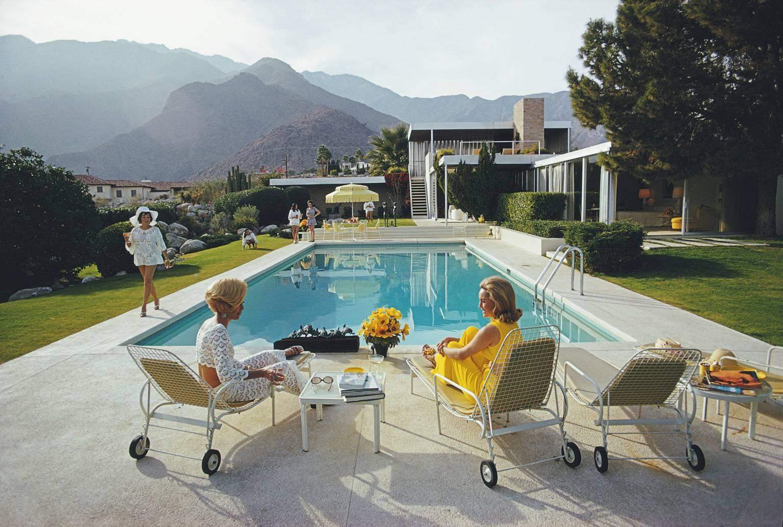 'Poolside Gossip' by Slim Aarons

Extra Large Oversize 40 x 30 inches  / 101 x 76 cm paper size

A true Slim Aarons Classic - it is considered to be a true modern masterpiece of photography. 

A poolside party at a desert house, designed by Richard