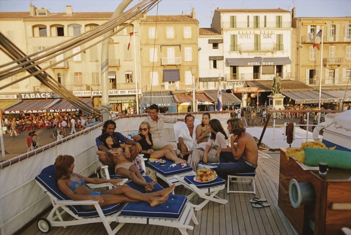 'Saint Tropez'   Slim Aarons Estate Edition (to 150 only)

Numbered & emboss stamped on front.

Holidaymakers on the deck of yacht in Saint-Tropez, France, August 1971. 

In his words, he loved to photograph 'beautiful people in beautiful places,