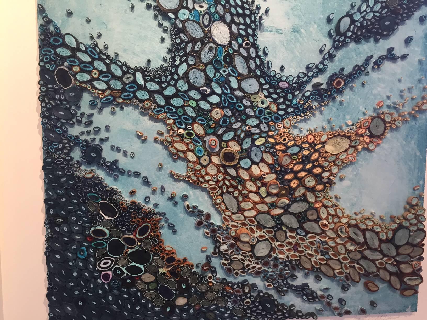 This blue mixed media piece is by Amy Genser who makes dimensional paper collages. These colorful, textural, one-of-a-kind wall pieces embody movement and processes. She masterfully manipulates paper -- each piece being cut, rolled and stacked -- to