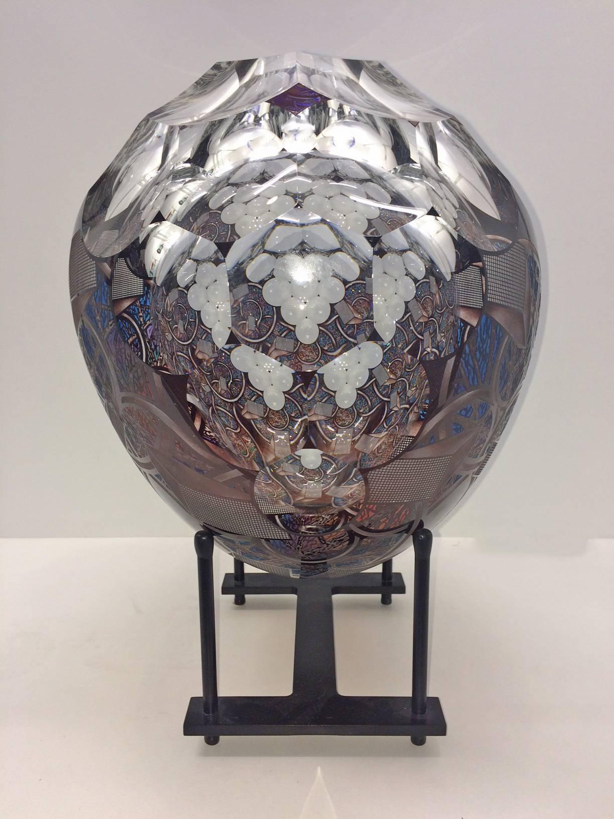 David Schwarz is currently recognized for his  Z-Axis series, where he creates an illusion of inner space. His pieces are created from clear glass with colored glass overlays. Each one is then faceted and etched to create illusions of perspective,