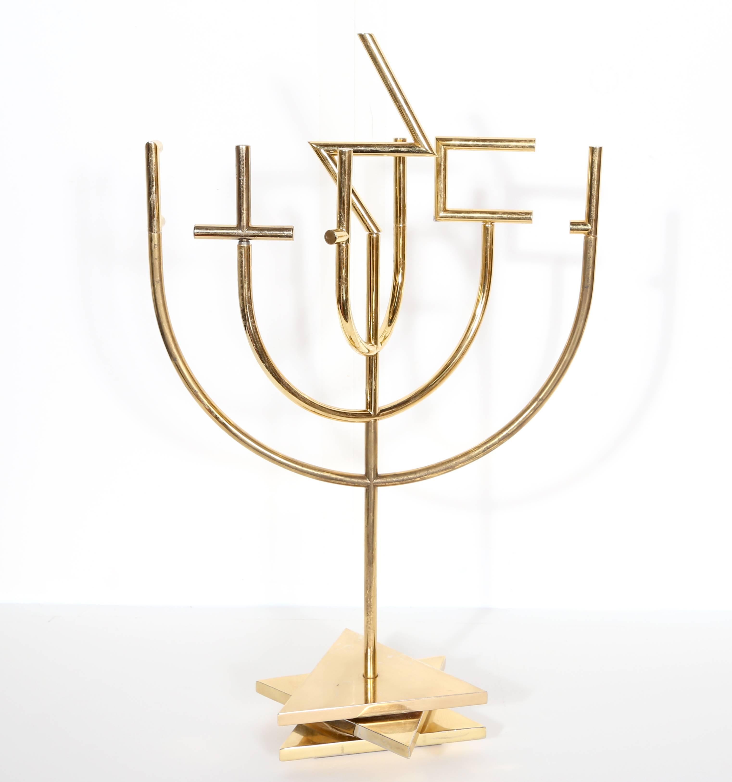 Artist: Yaacov Agam, Israeli (1928 - )
Title: Shalom Menorah (Tri-Base)
Year: circa 1980 
Medium: Gold-Plated Metal Kinetic Sculpture, signature and number inscribed
Edition: 180
Size: 18 x 11 x 5 in. (45.72 x 27.94 x 12.7 cm)

Comes with