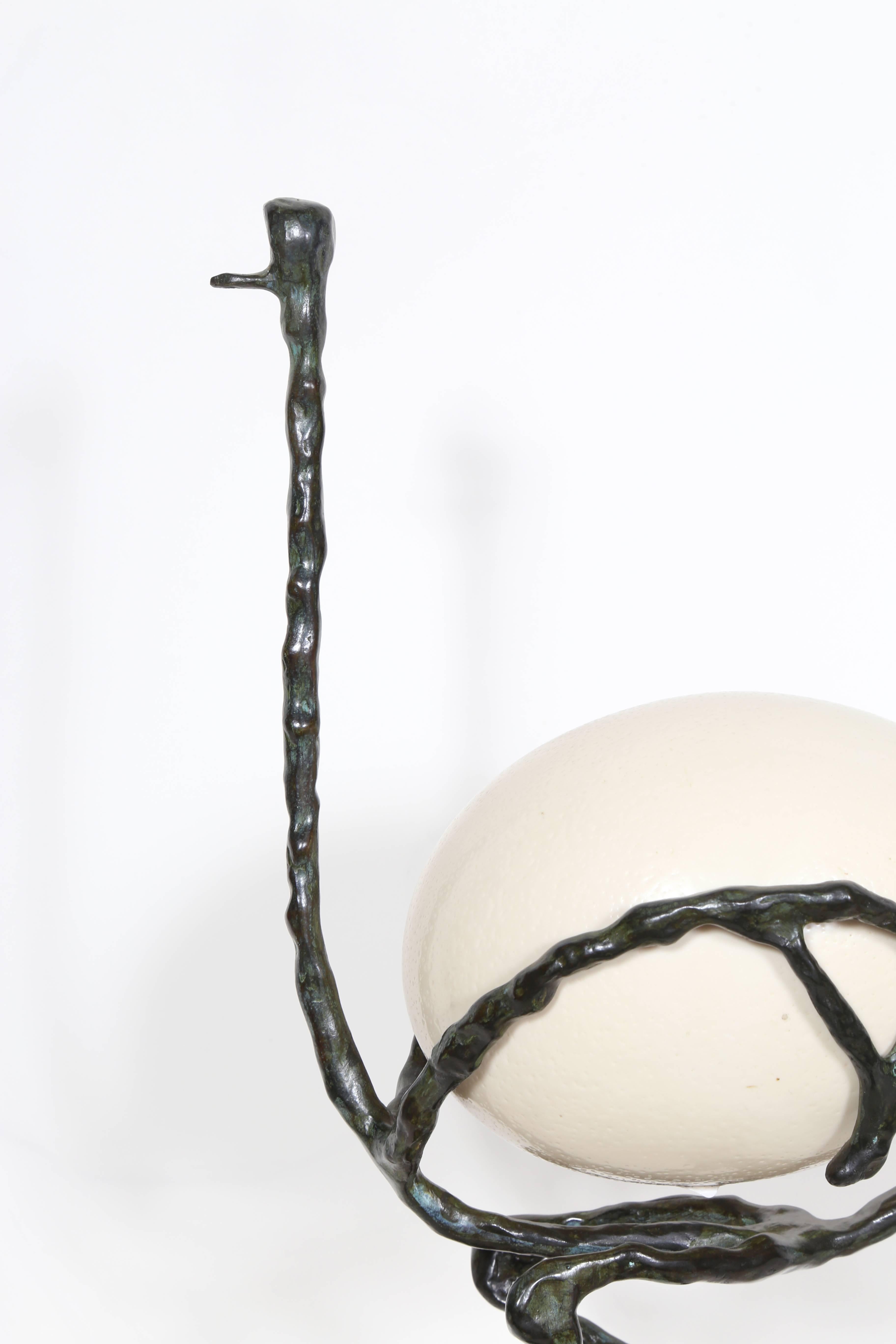 Artist: Diego Giacometti, Swiss (1902 - 1985)
Title: L'Autruche (The Ostrich)
Medium: Bronze Sculpture with Ostrich Egg, signed 'Diego' on base
Size: 19.5  x 5.5  x 10.5 in. (49.53  x 13.97  x 26.67 cm)
