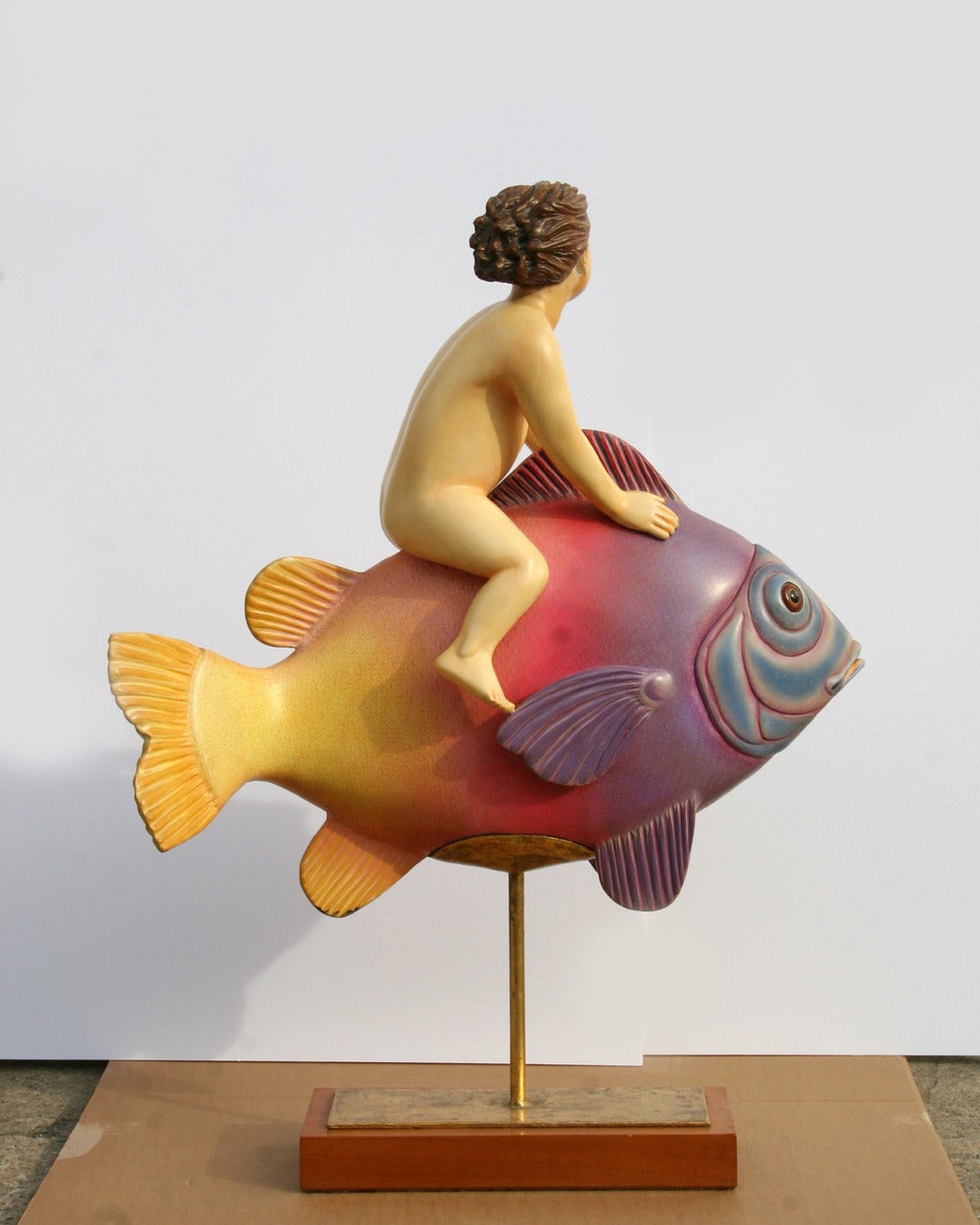 A resin sculpture by Sergio Bustamante from 1987. A piece from Bustamante's animal sculpture period in which his whimsical style is portrayed in fantasy-like animal figures. 

Artist: Sergio Bustamante, Mexican
Title:	Flying Fish with Boy
Year: 1987