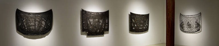 Text by Sophie Lynch	

For the exhibition Veiled Hoods and Stains, Cal Lane combines delicate lacework and discarded steel car and truck hoods to create two series of related works. Traditionally used as a symbol of purity to adorn clerical robes,