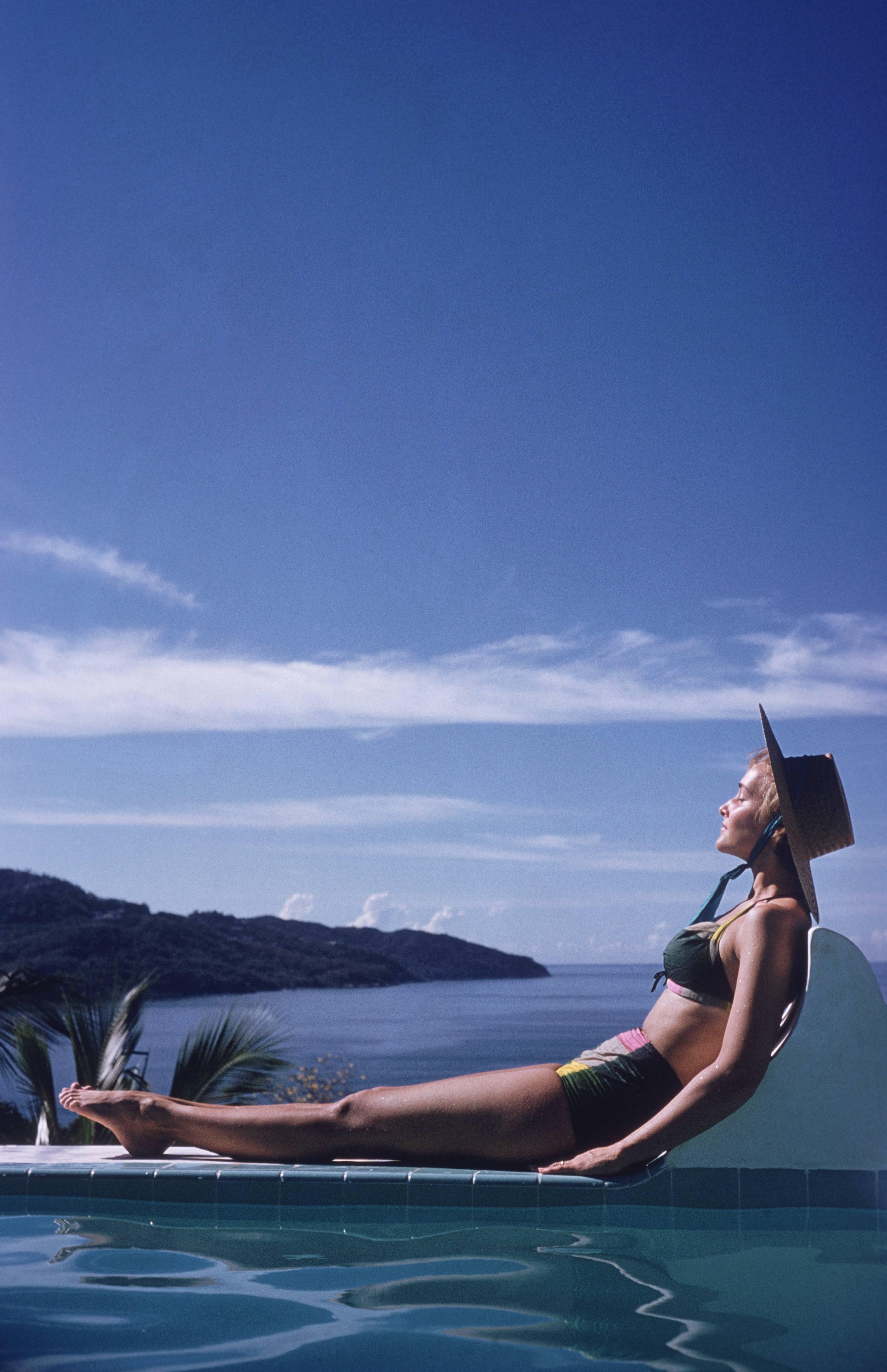 Ingrid Morath sunbathes by a swimming pool next to the sea in Acapulco, January 1961. Ingrid was born in Rio de Janeiro and lives in Mexico City. (Photo by Slim Aarons/Getty Images)

C-type print from the original transparency held at the Getty
