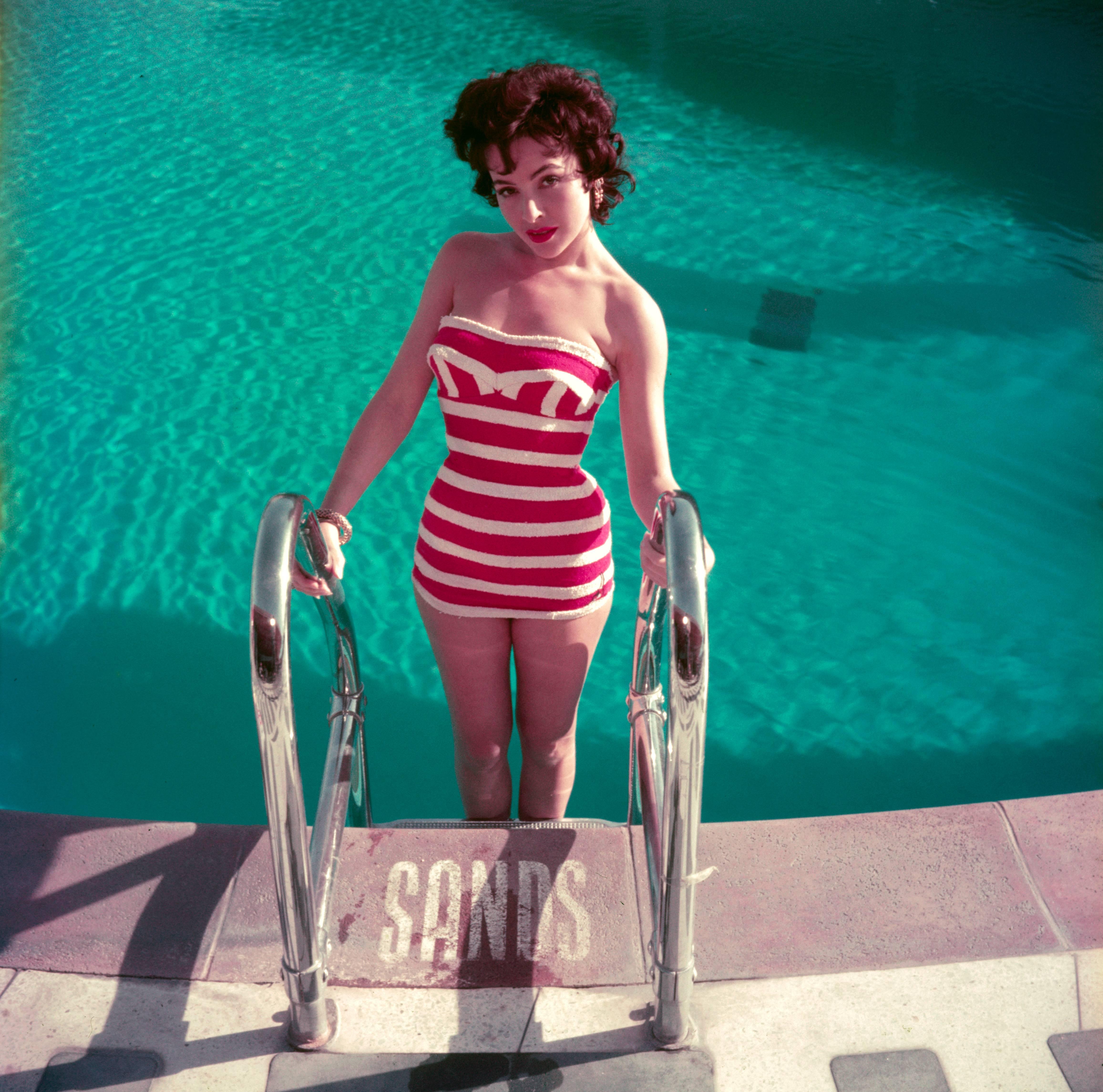 1954: Austrian actress Mara Lane posing by the pool at the Sands Hotel, Las Vegas, in a red and white striped bathing costume.

C-type print from the original transparency held at the Getty Images Archive, London.  Numbered and stamped by The Slim