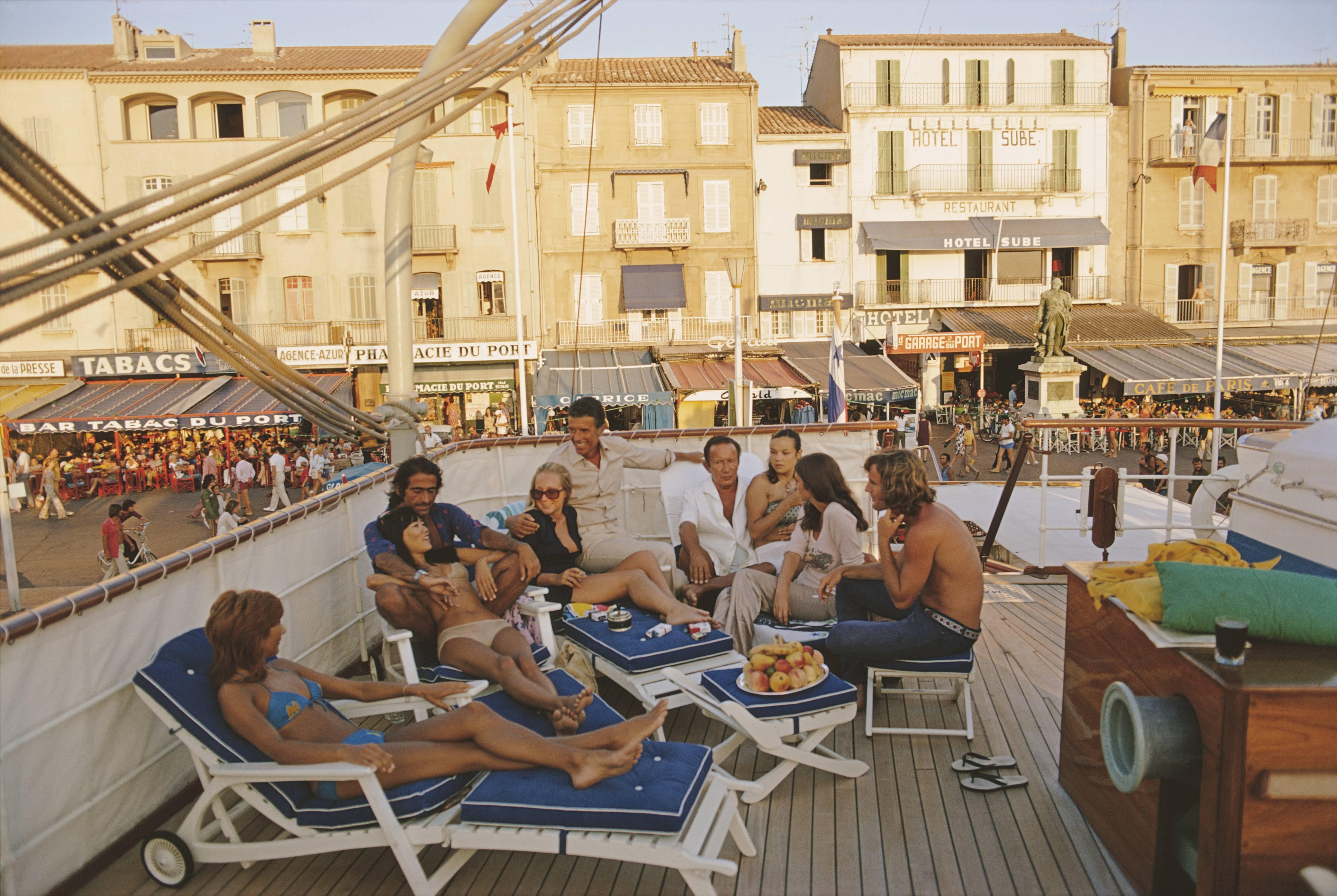 Holidaymakers on the deck of yacht in Saint-Tropez, France, August 1971. (Photo by Slim Aarons/Getty Images)

C-type print from the original transparency held at the Getty Images Archive, London.  Numbered and stamped by The Slim Aarons Estate. 