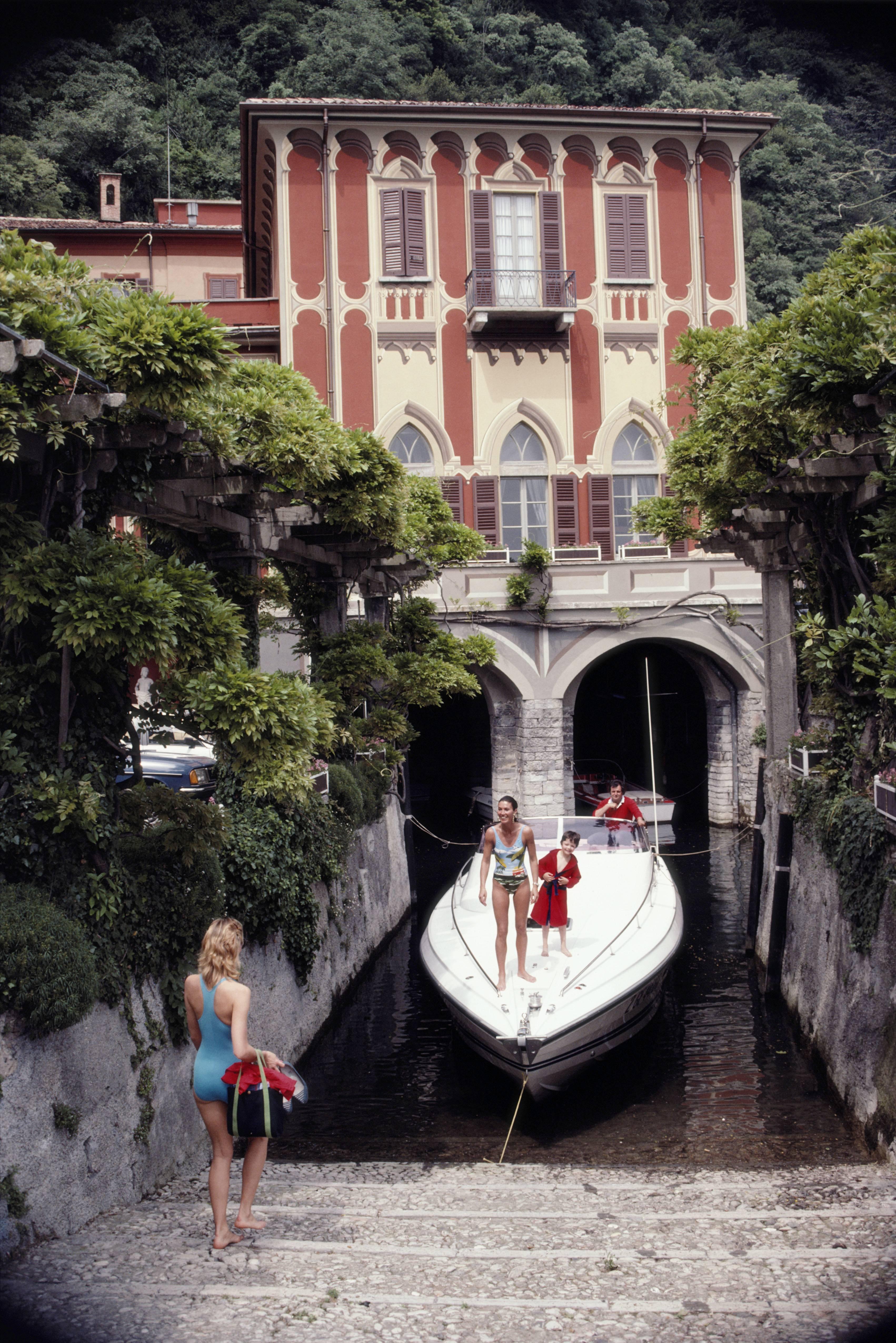 Tullio Abbate, of Abbate Boats, at the back of yacht as it is moored at a property on the shores of Lake Como, Italy, in June 1983. (Photo by Slim Aarons/Getty Images)

C-type print from the original transparency held at the Getty Images Archive,