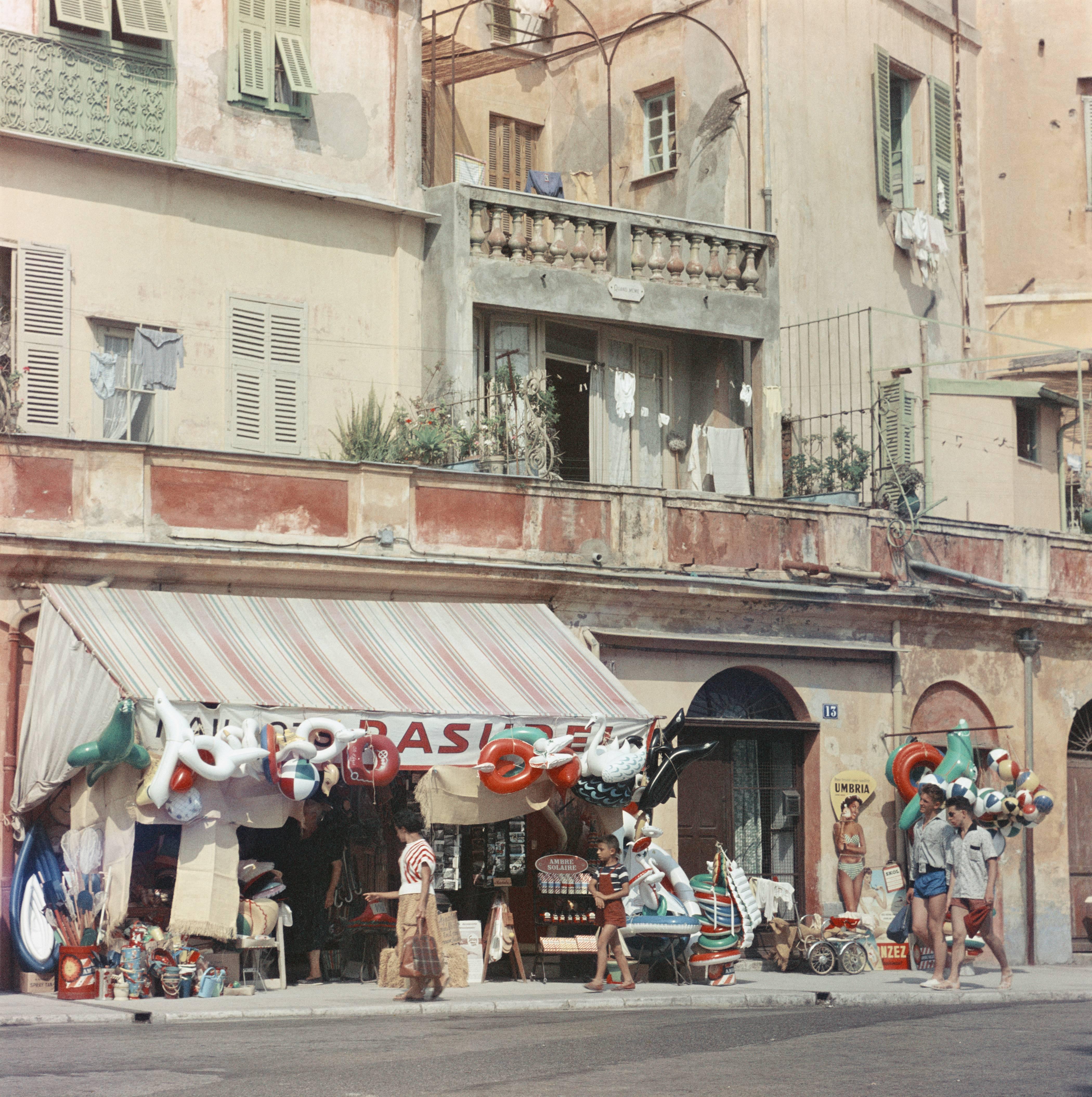 A shop selling beach paraphernalia in Menton, in southeastern France, 1957. (Photo by Slim Aarons/Getty Images)

C-type print from the original transparency held at the Getty Images Archive, London.  Numbered and stamped by The Slim Aarons Estate. 