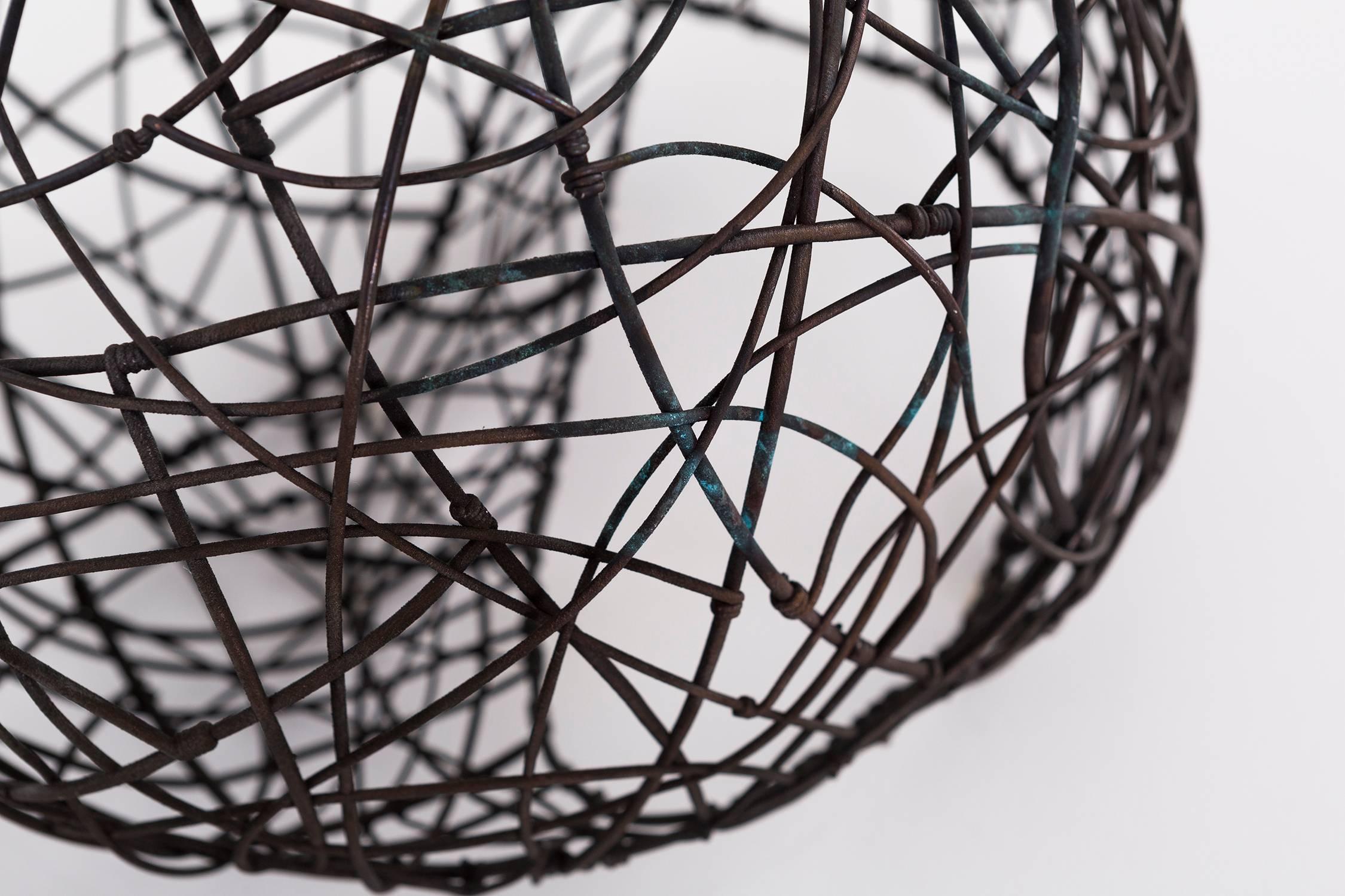 "W / 074" is a stunning, intricately laced copper wire sculpture. Unbelievably textural and inspiring a tactile interaction, this sculpture by Frank Connet is incredibly versatile -- it can be suspended, hooked to a wall or simply stand on