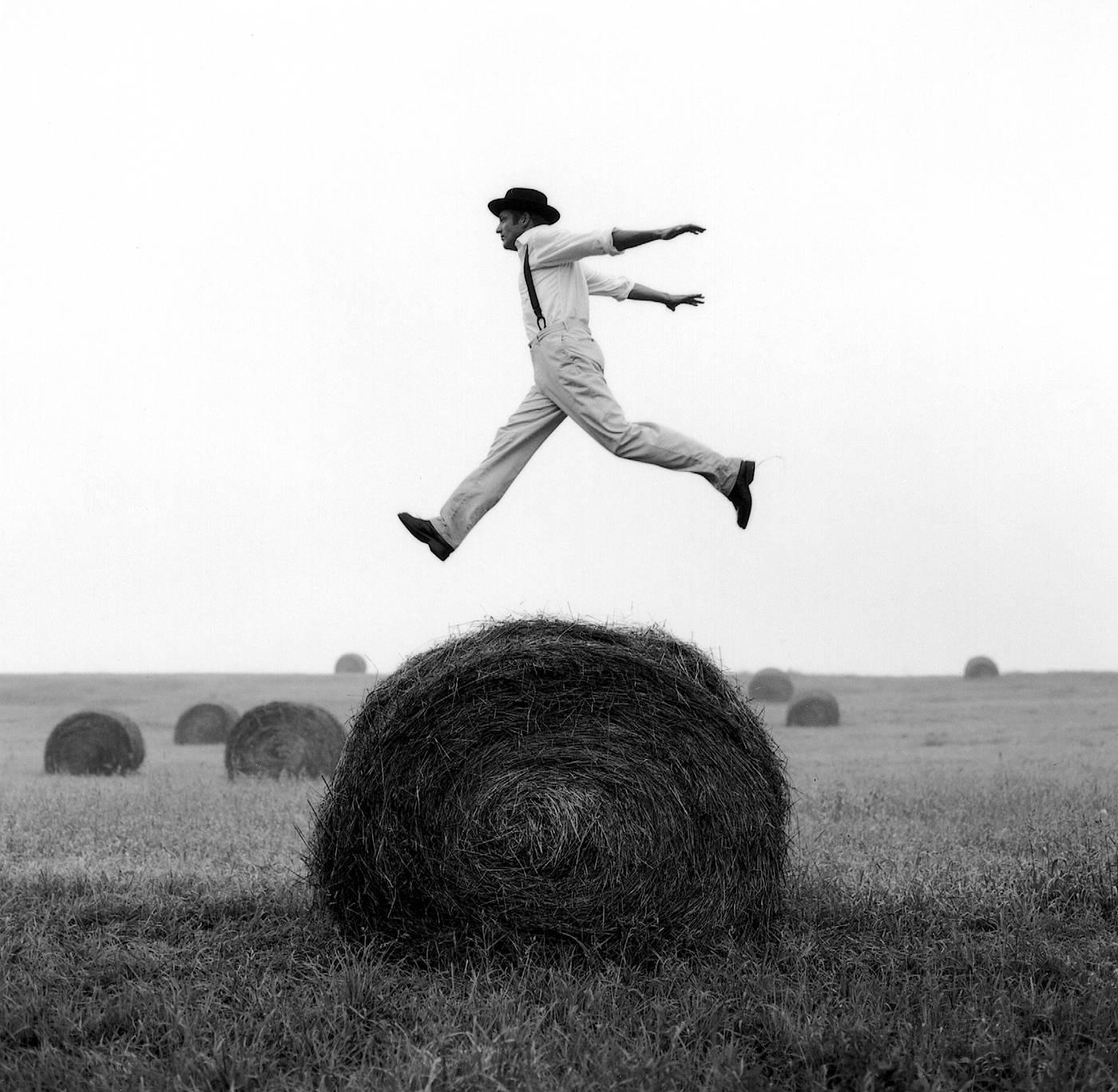 Rodney Smith Black and White Photograph - Don Jumping over Hay Roll, Monkton, MD