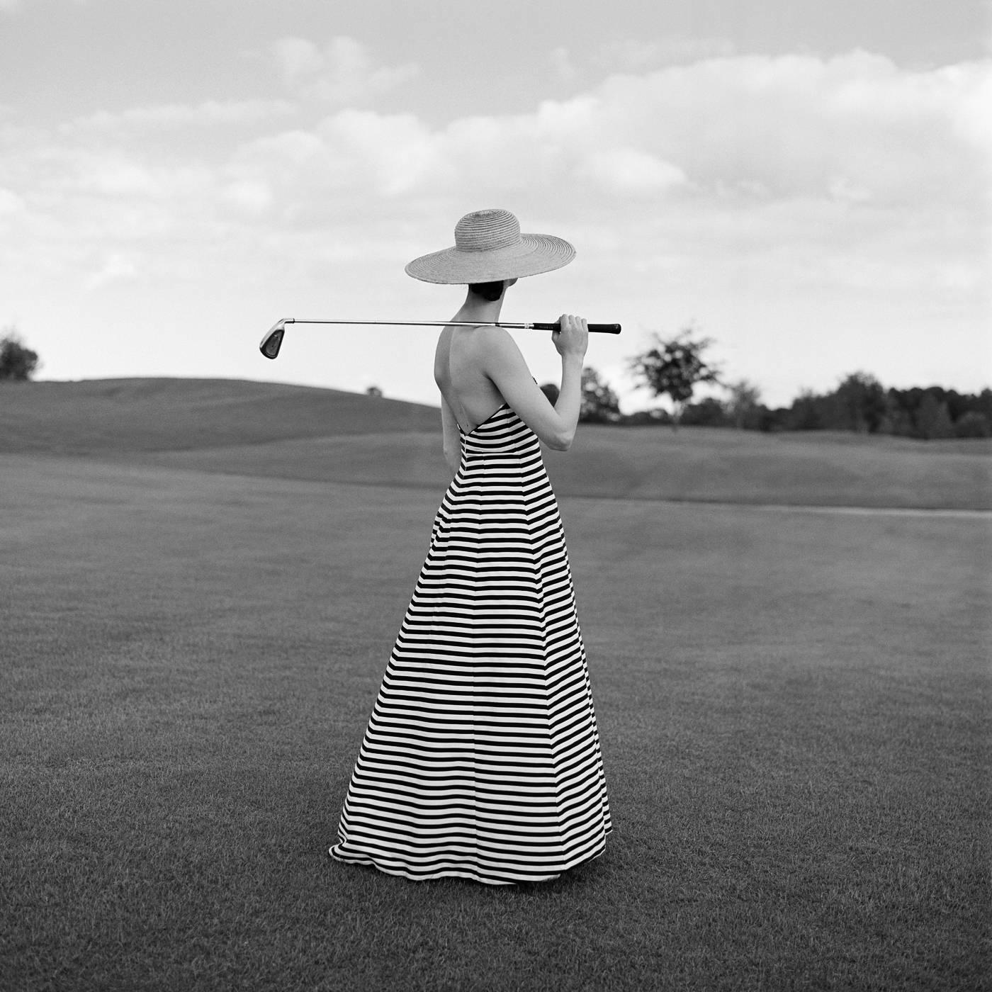 Rodney Smith Figurative Photograph - Caroline Golfing in Striped Dress, St. Augustine FL - 20 x 20 inches