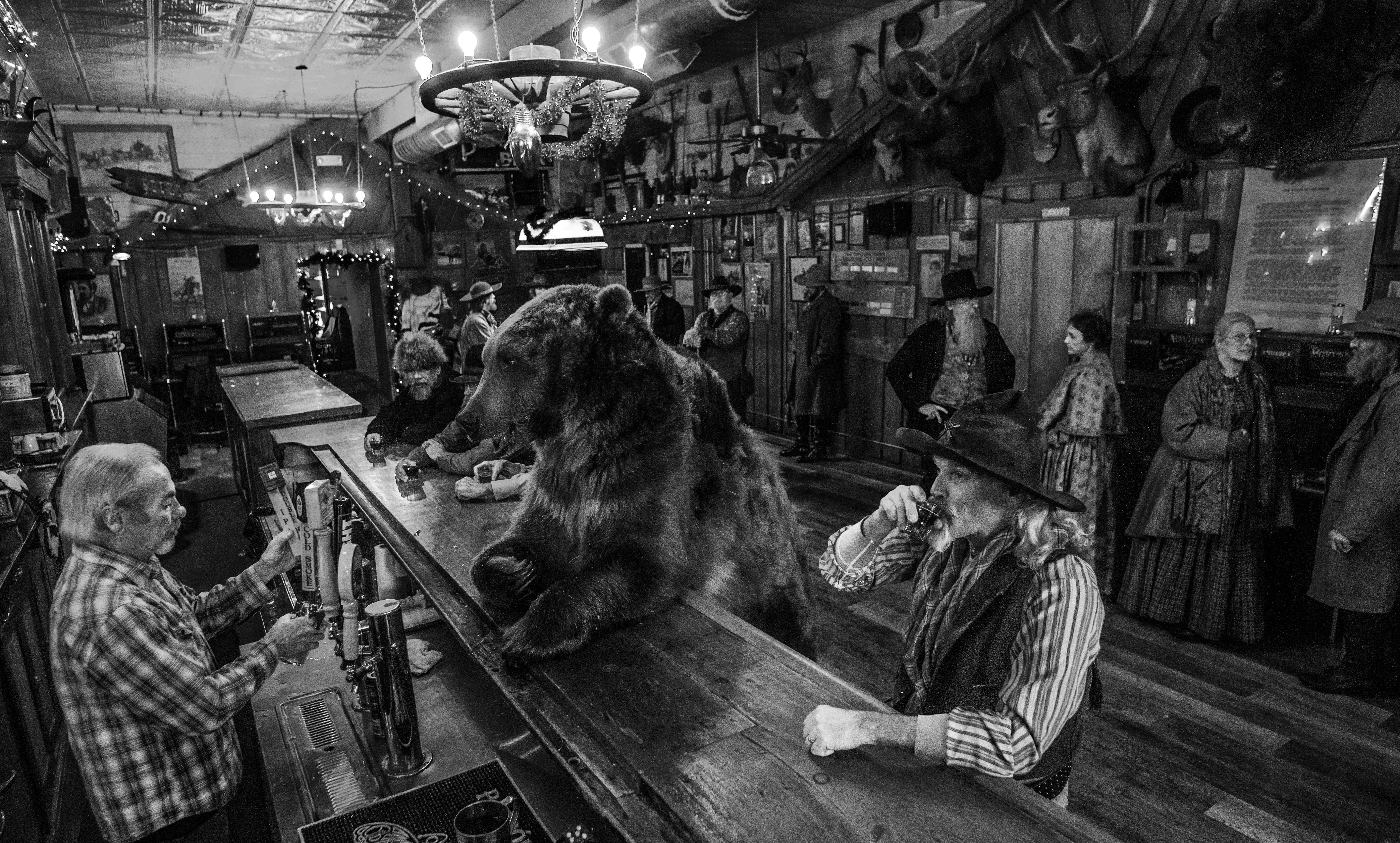 David Yarrow Black and White Photograph - I've Got One....A Bear Walks Into a Bar