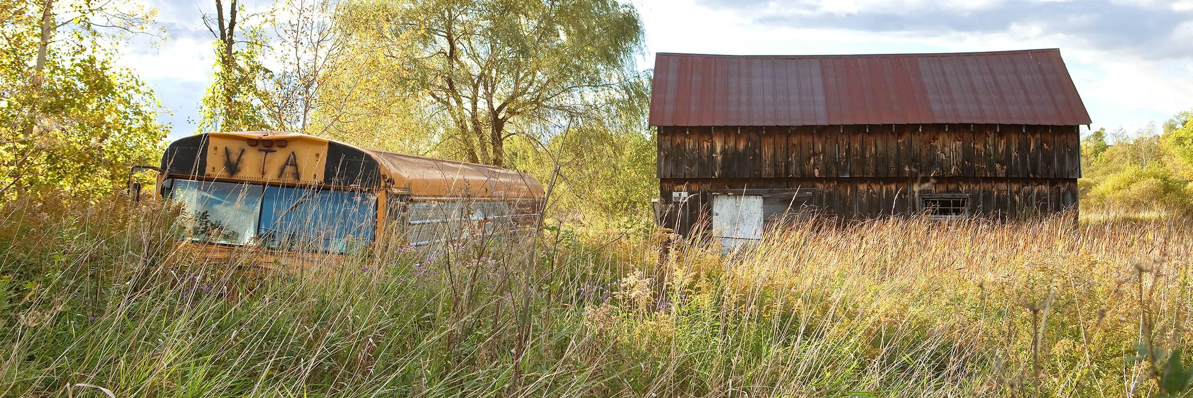 Rebecca Skinner Landscape Photograph - "Forgotten Beauty", landscape, panoramic, bus, barn, Vermont, color photograph