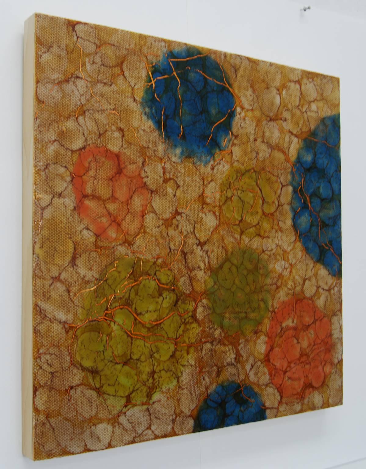 Kay Hartung's “Macrocell 1” is a richly patterned painting in colors of amber, blue and orange. She embeds fabric netting into the encaustic layers creating a webbed effect. The painting is 24 x 24 inches on birch panel. 

Kay Hartung is an artist