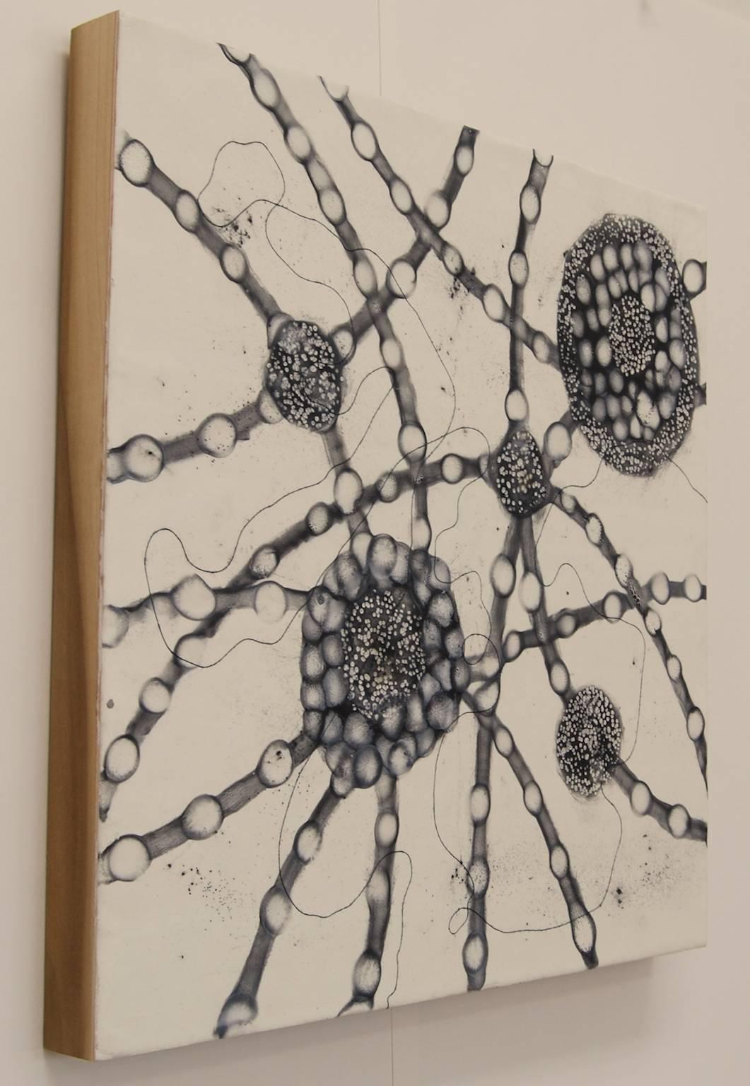Kay Hartung's “Cells Alive 6” is a striking representation of microscopic activity in black and white. Using powdered graphite on white encaustic, she creates the imagery by moving the graphite around the surface with a small torch. The painting is