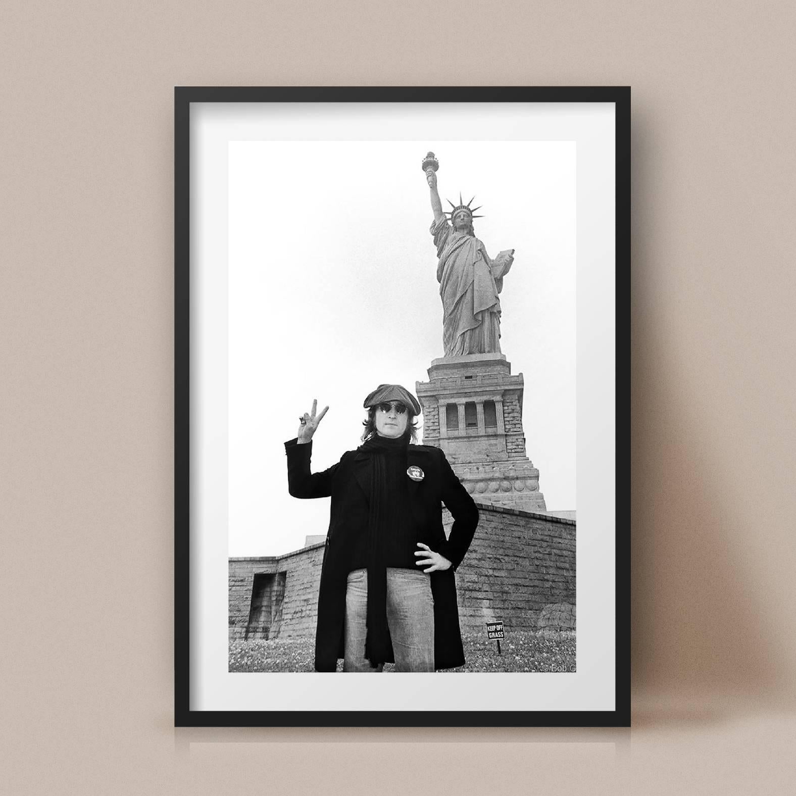 john lennon in front of statue of liberty