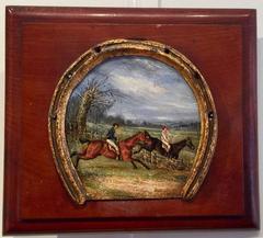 English Point to point race with horses jumping over a fence