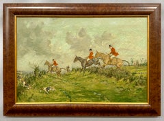 Early 20th century English Fox Huntsman jumping over a hedge with Hounds
