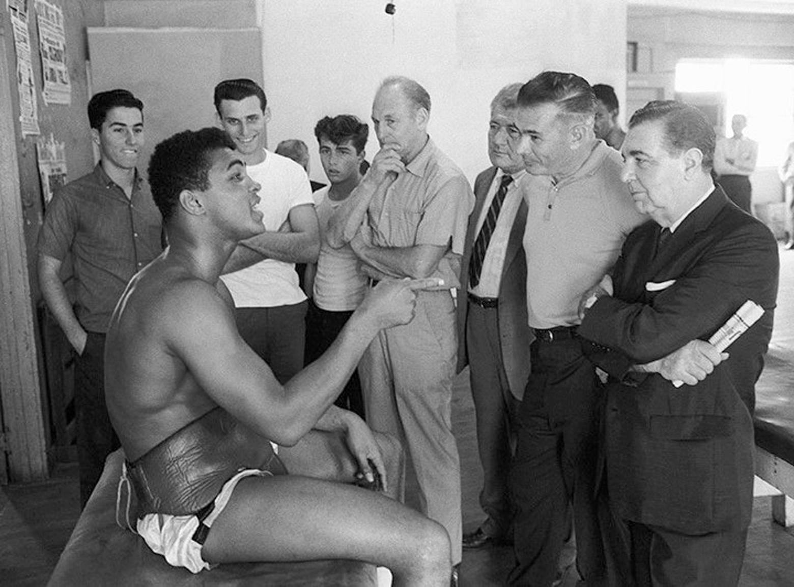 Marvin Newman Figurative Photograph - Cassius Clay with Newspaper Sports Writers, Black & White Photography