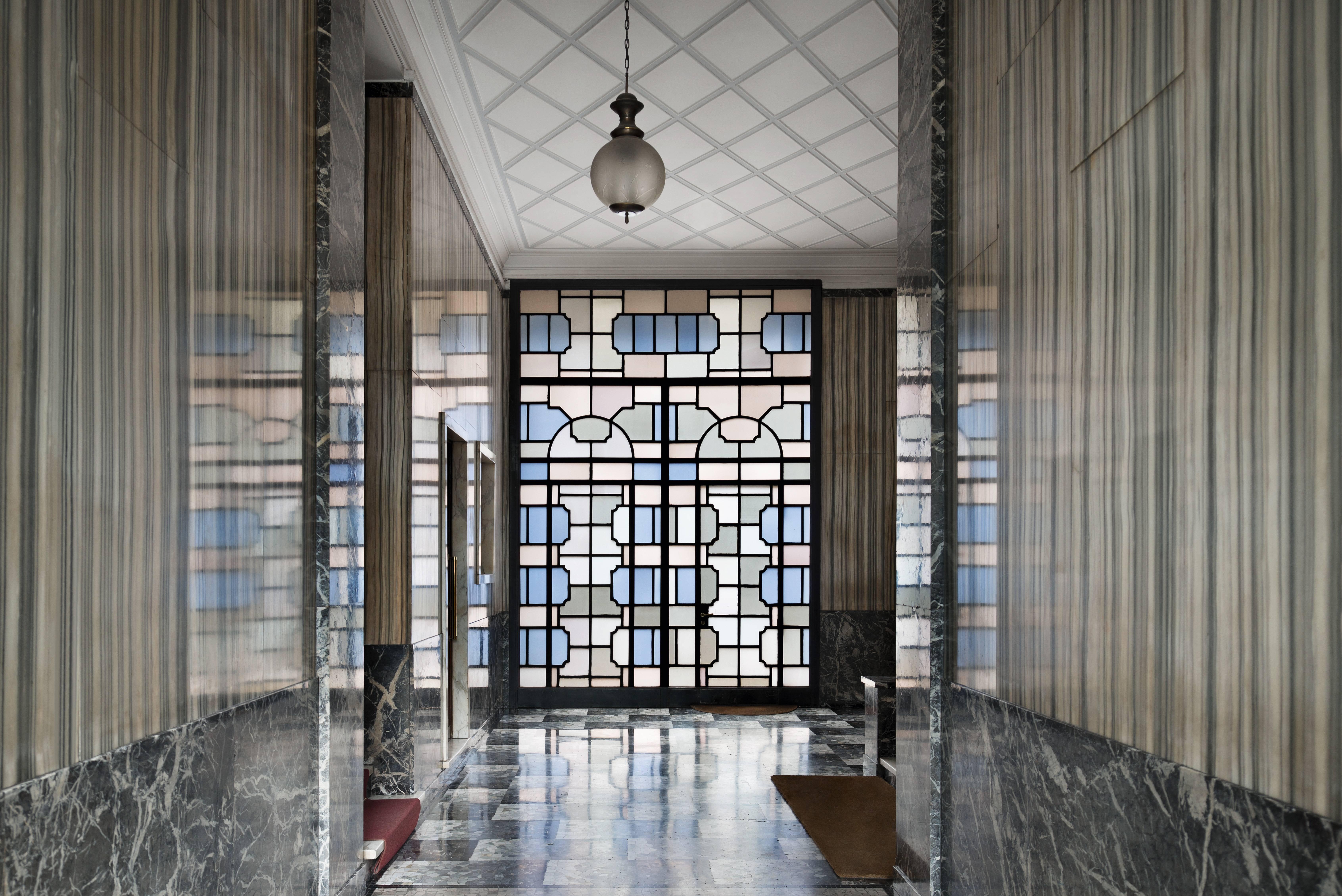 Paola Pansini Color Photograph - Ingressi di Milano. piazza VI Febbraio 10, Interior Architecture Photography