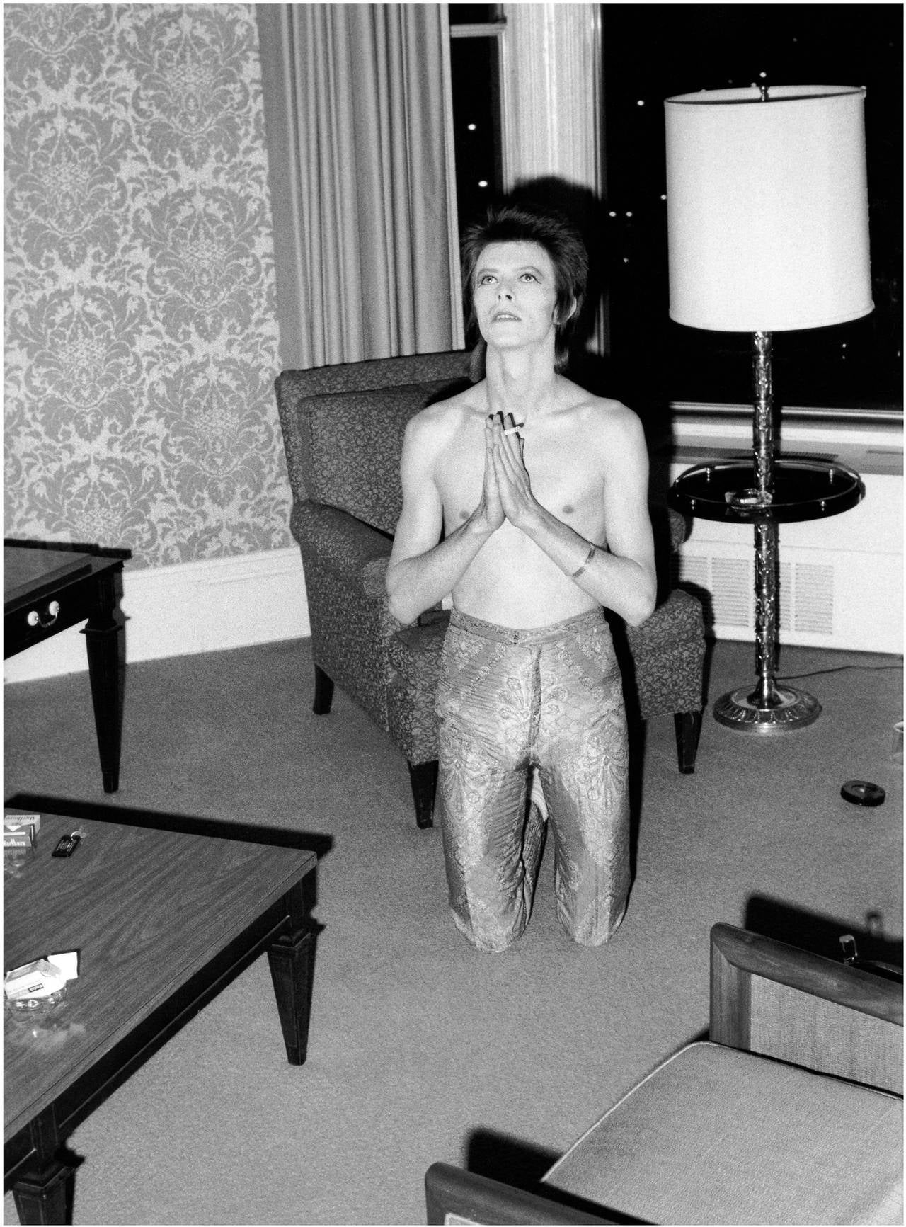 Mick Rock Figurative Photograph - Bowie Praying on Knees