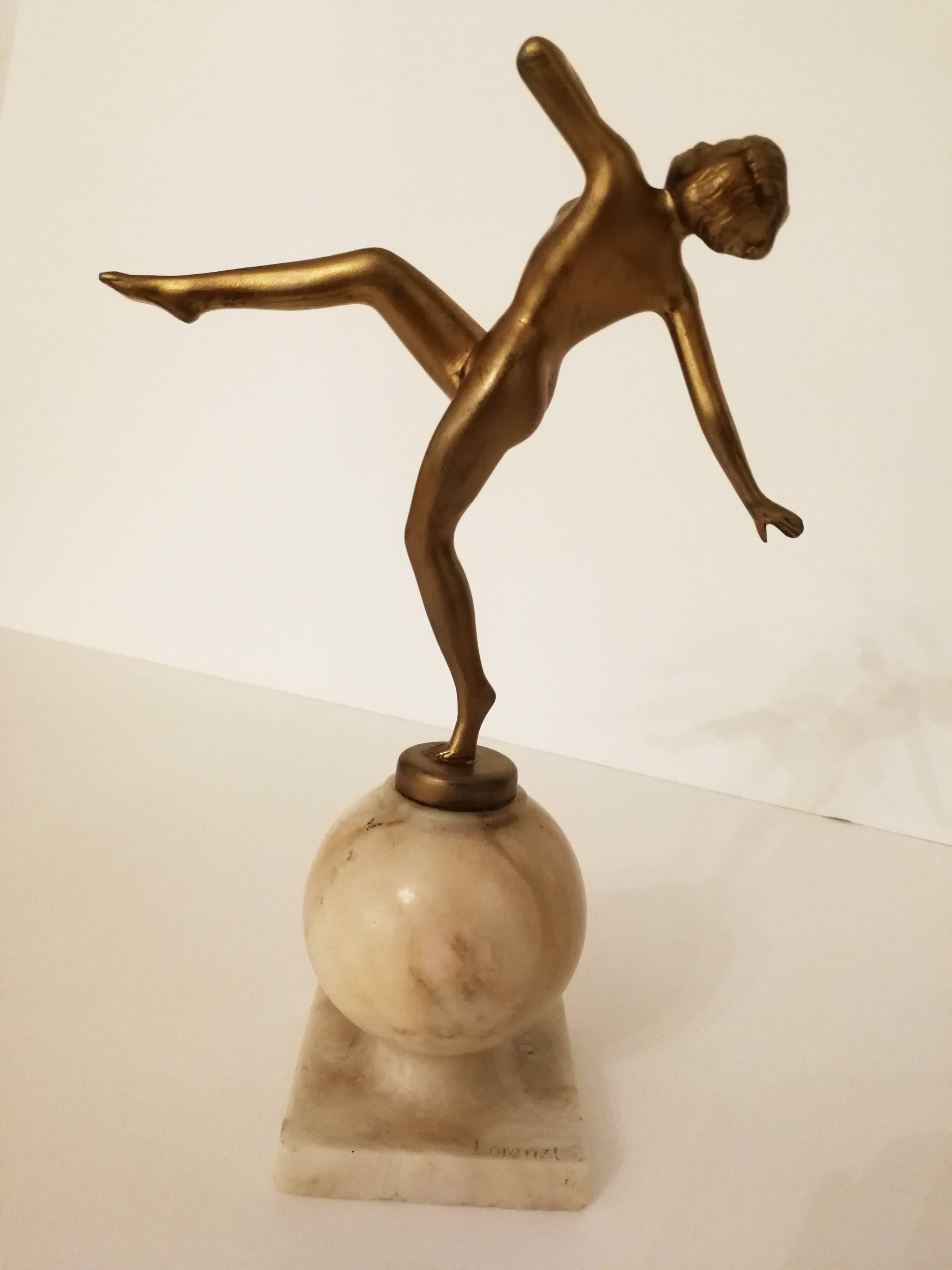 The attractive, naked golden figure is raising her leg and looking upwards in a dancing movement. The surface of her skin is completely smooth. She is standing on a little golden pedestal, which is placed on a ball formed marble base.

ARTIST
Josef
