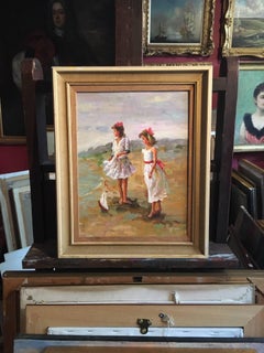 Young Children Playing on a Beach with a Toy Boat