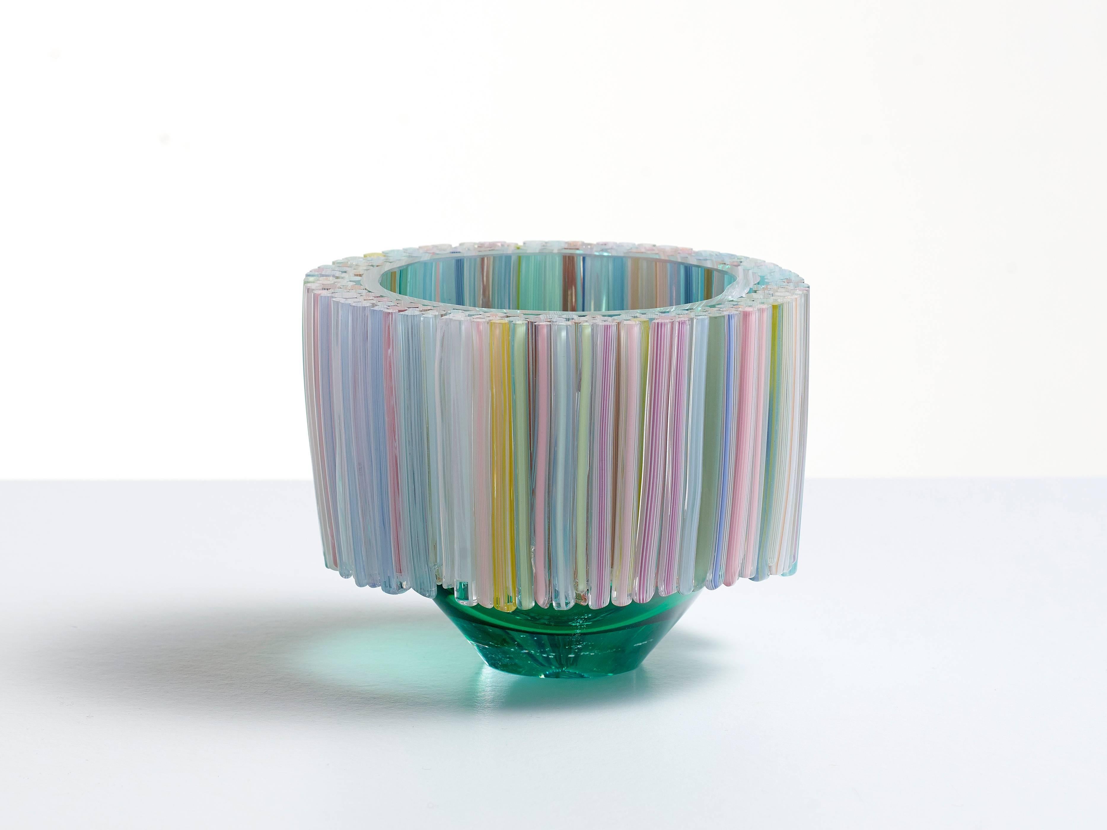 This beautiful blown glass green bowl is decorated with hand crafted glass threads that are melted to the body of the glass vessel. The many colors of the threads like, green, pink, purple, yellow and white are stylishly combined, resulting in a