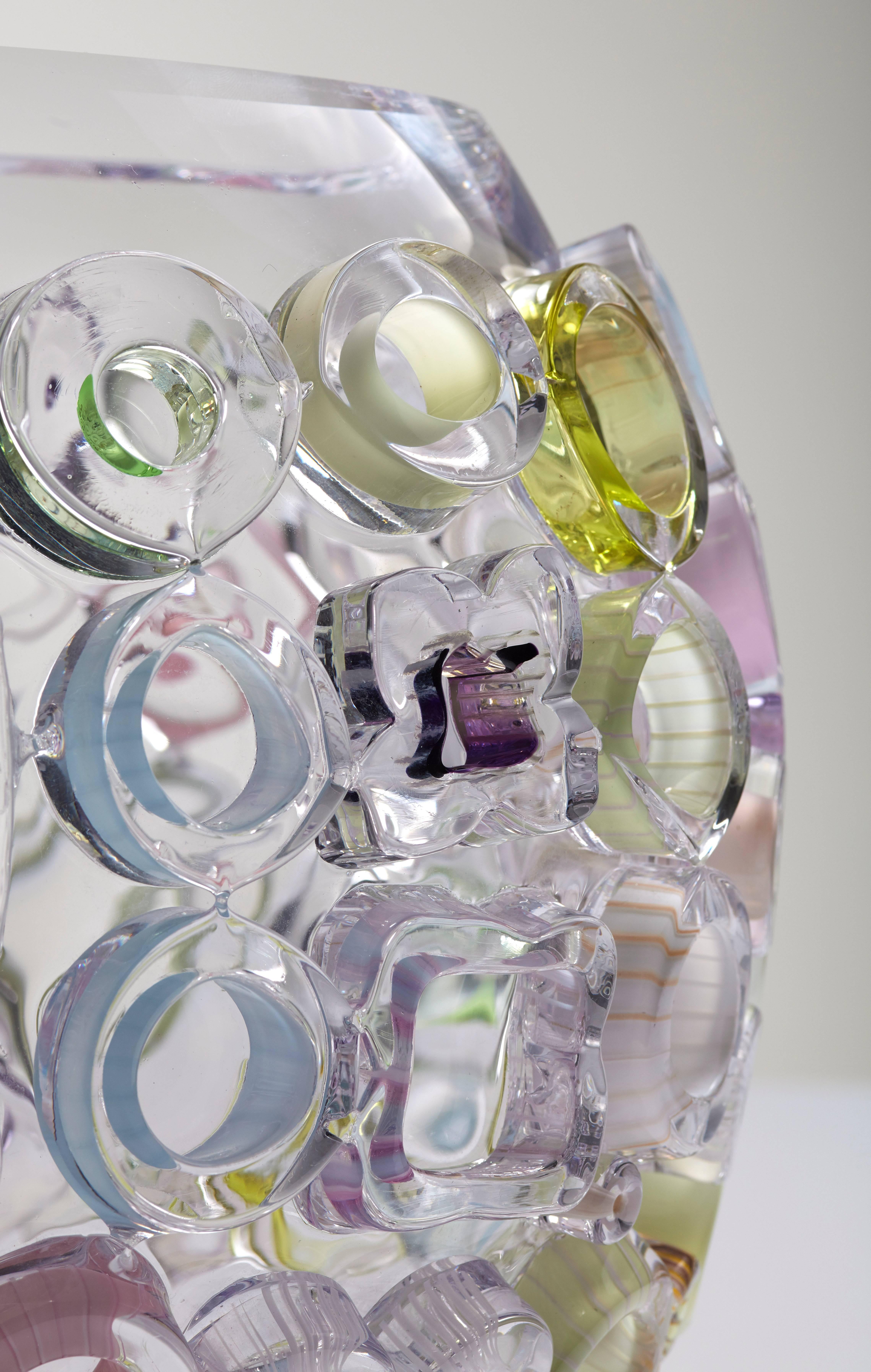Blown glass bowl shaped Sculpture. Translucent blown glass with glass ornaments melted to the body. The ornaments on the outside of the glass bowl contain subtle color applications in pastels like: pink, green, yellow, blue and purple.
Each