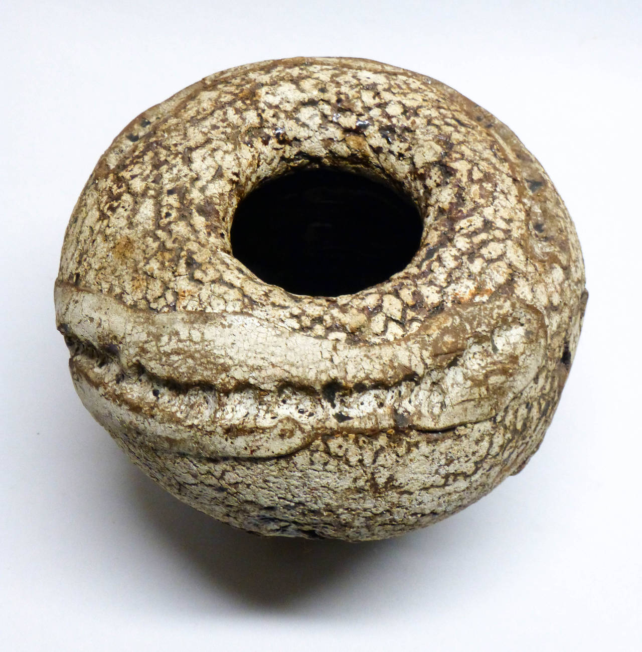 Here is a very bold sculptural brutalist vase by Yanagihara. This represents his early work produced here in Washington when teaching at the University of Washington in the 1960's. Very textural with tenmoku brown glazes.